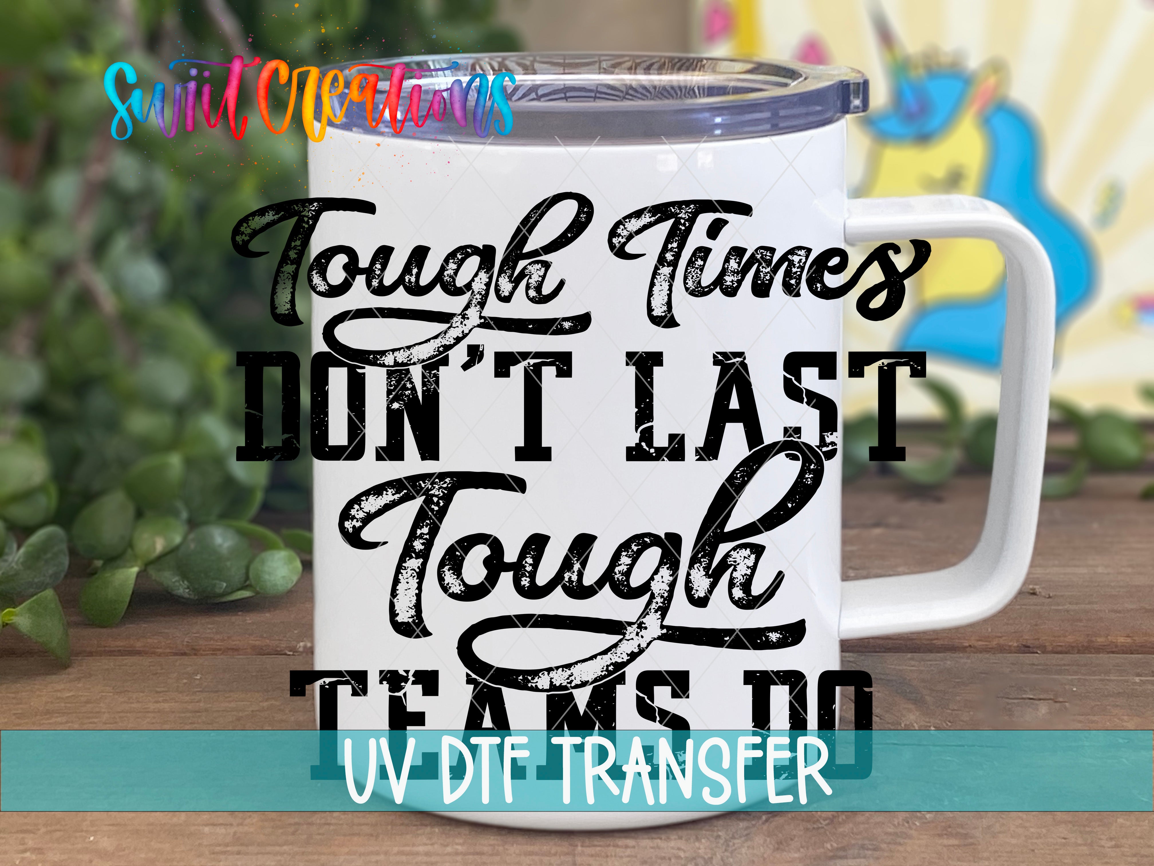 A white mug with a printed message that reads "Tough times don't last tough teams do" in a distressed font.