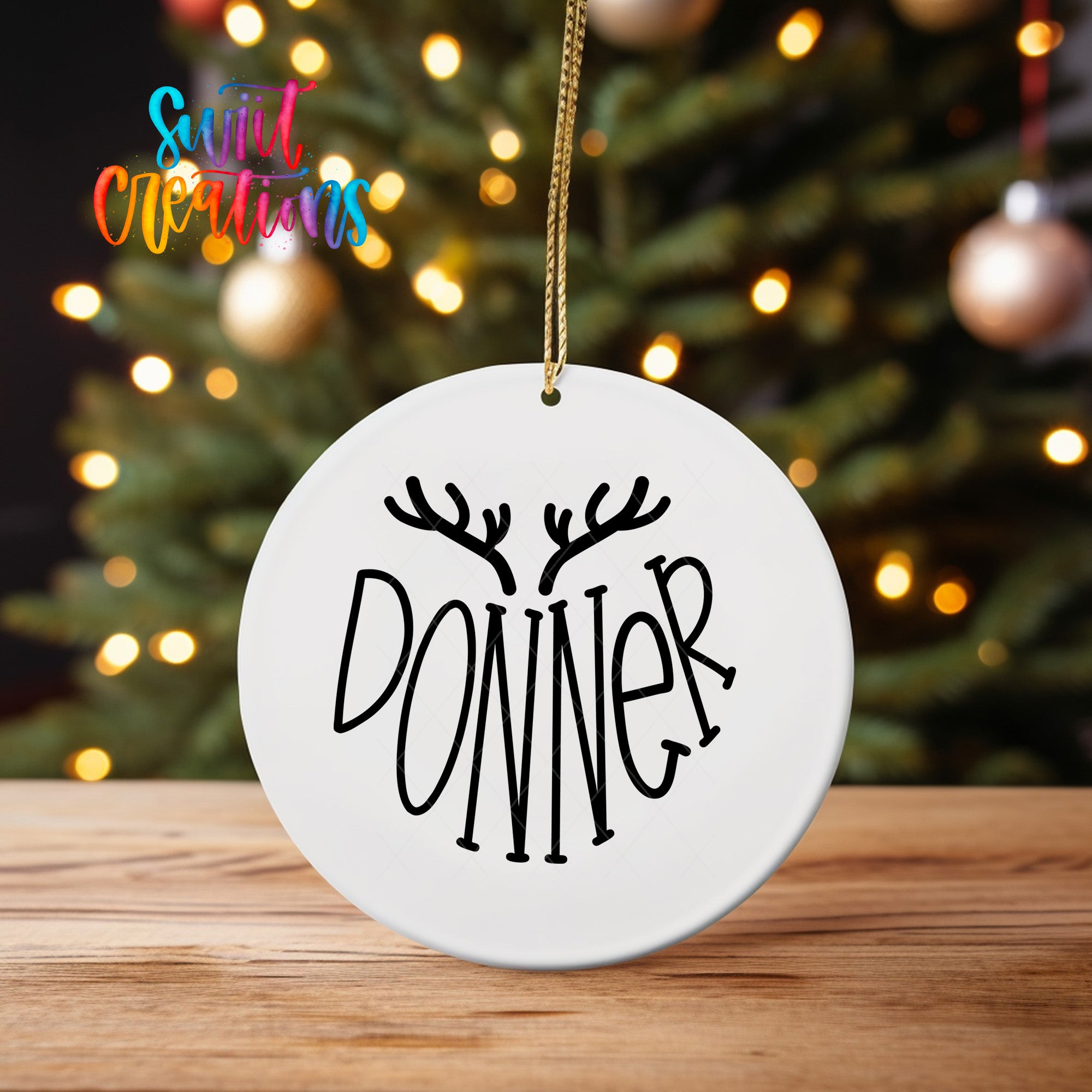 A white ornament with the word "DONNER" written on it, hanging from a string.