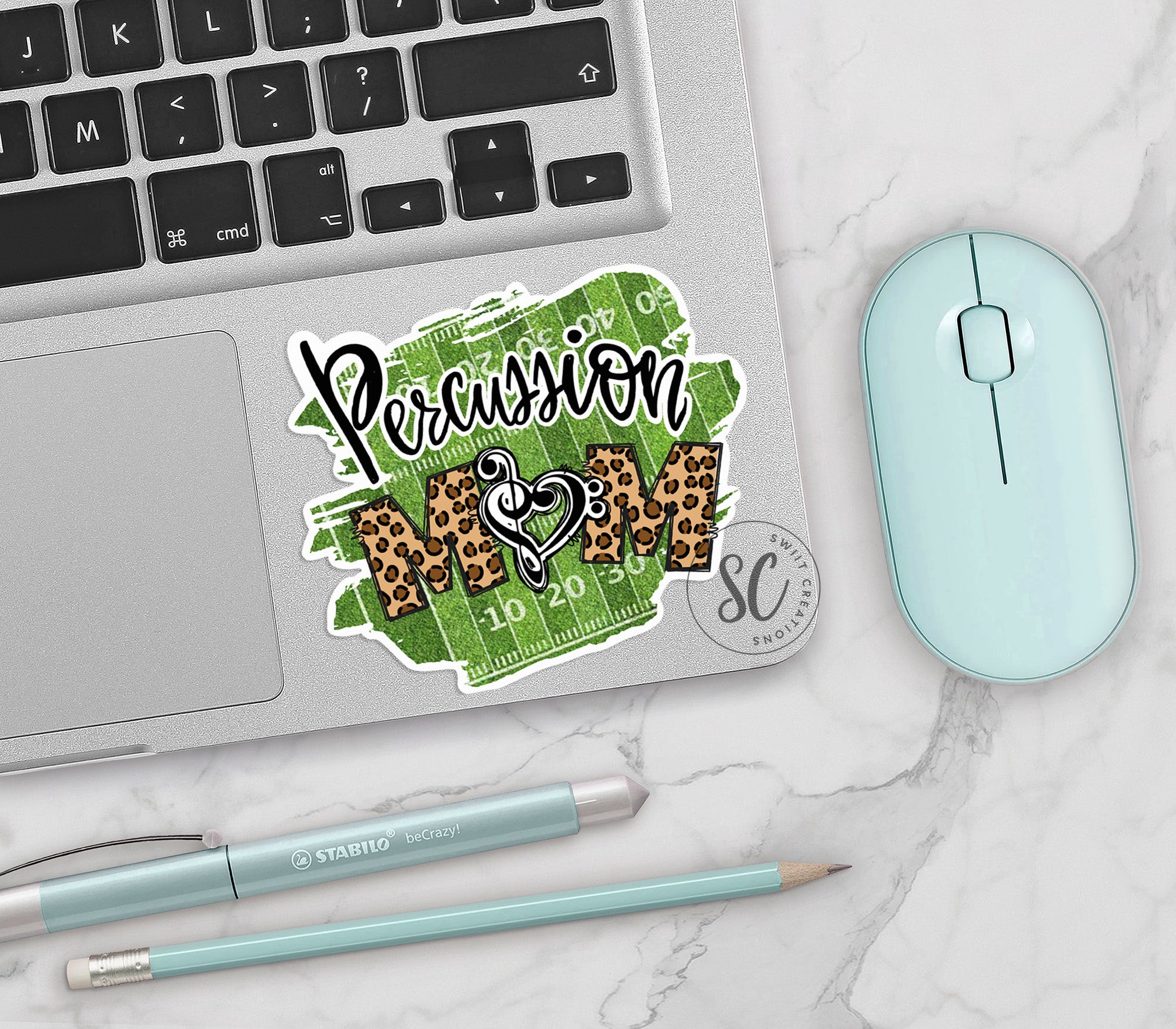 a laptop computer sitting on top of a desk next to a mouse