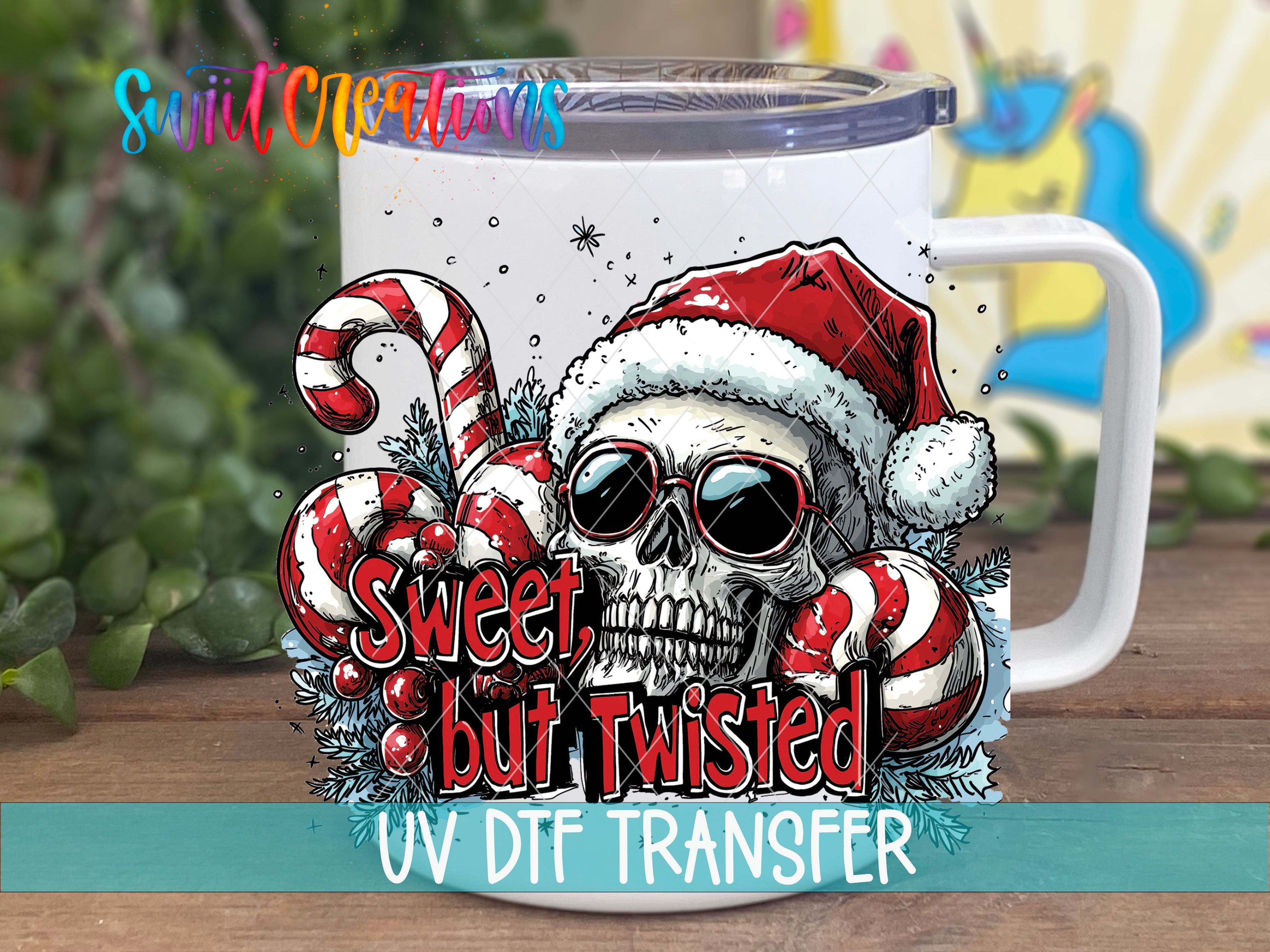A mug with a skull wearing a Santa hat and sunglasses, surrounded by candy canes and other festive elements, with the text "Sweet but Twisted UV DFT Transfer" below the mug.