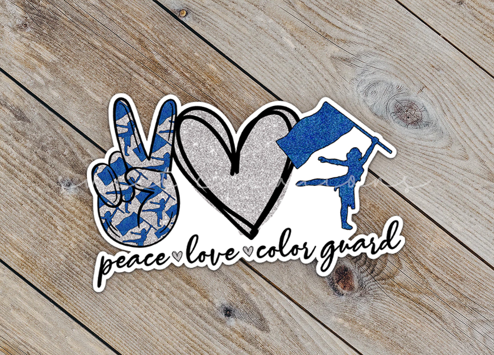 a peace love color guard sticker on a wooden surface