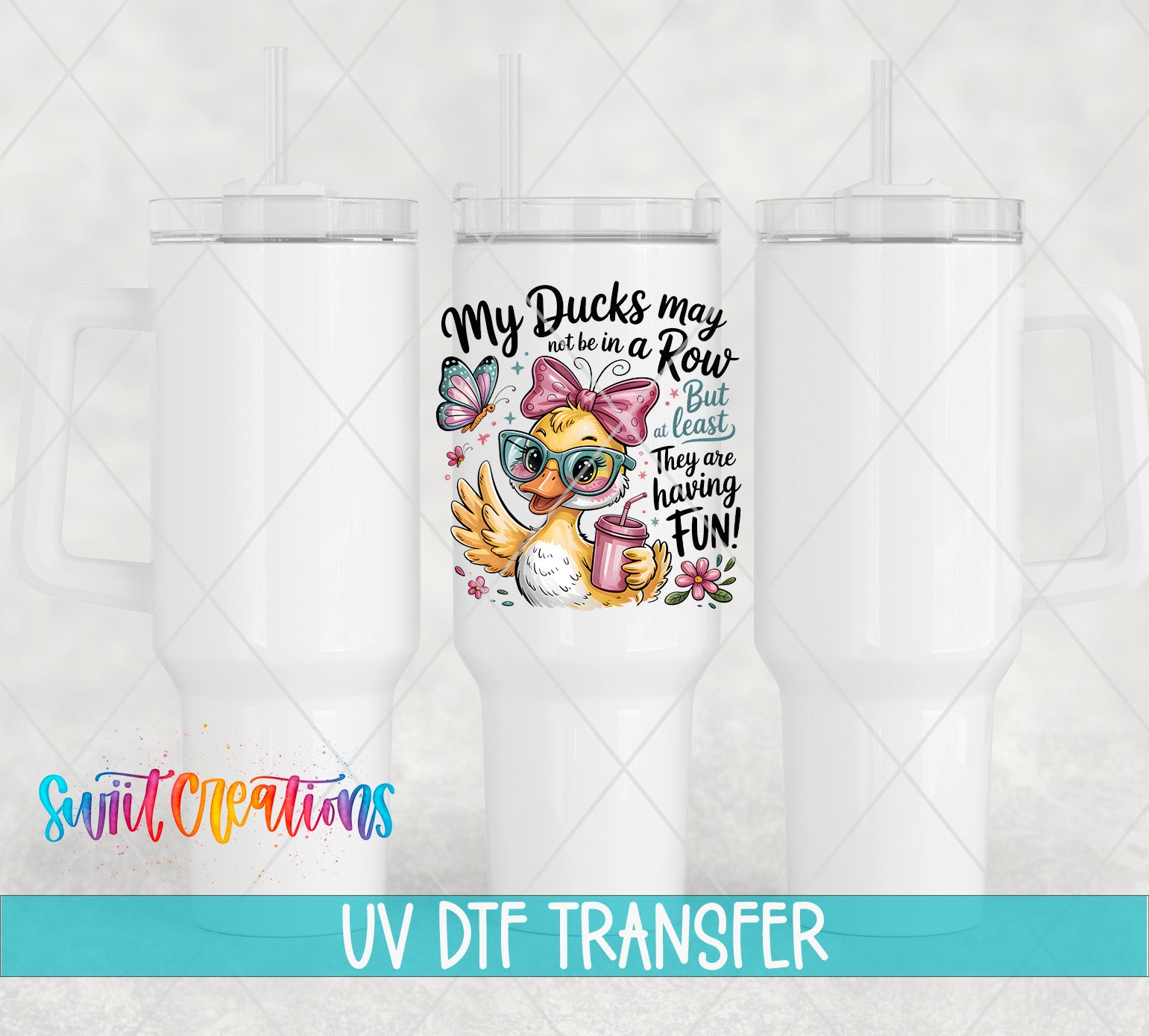 a white ceramic mug with a colorful and whimsical design, including a duck wearing sunglasses and holding a cup. The mug is accompanied by text that reads "My Ducks may be in a Row but they are least having fun!" The mug is part of a collection of similar items, as indicated by the UV DFT Transfer text at the bottom of the image.