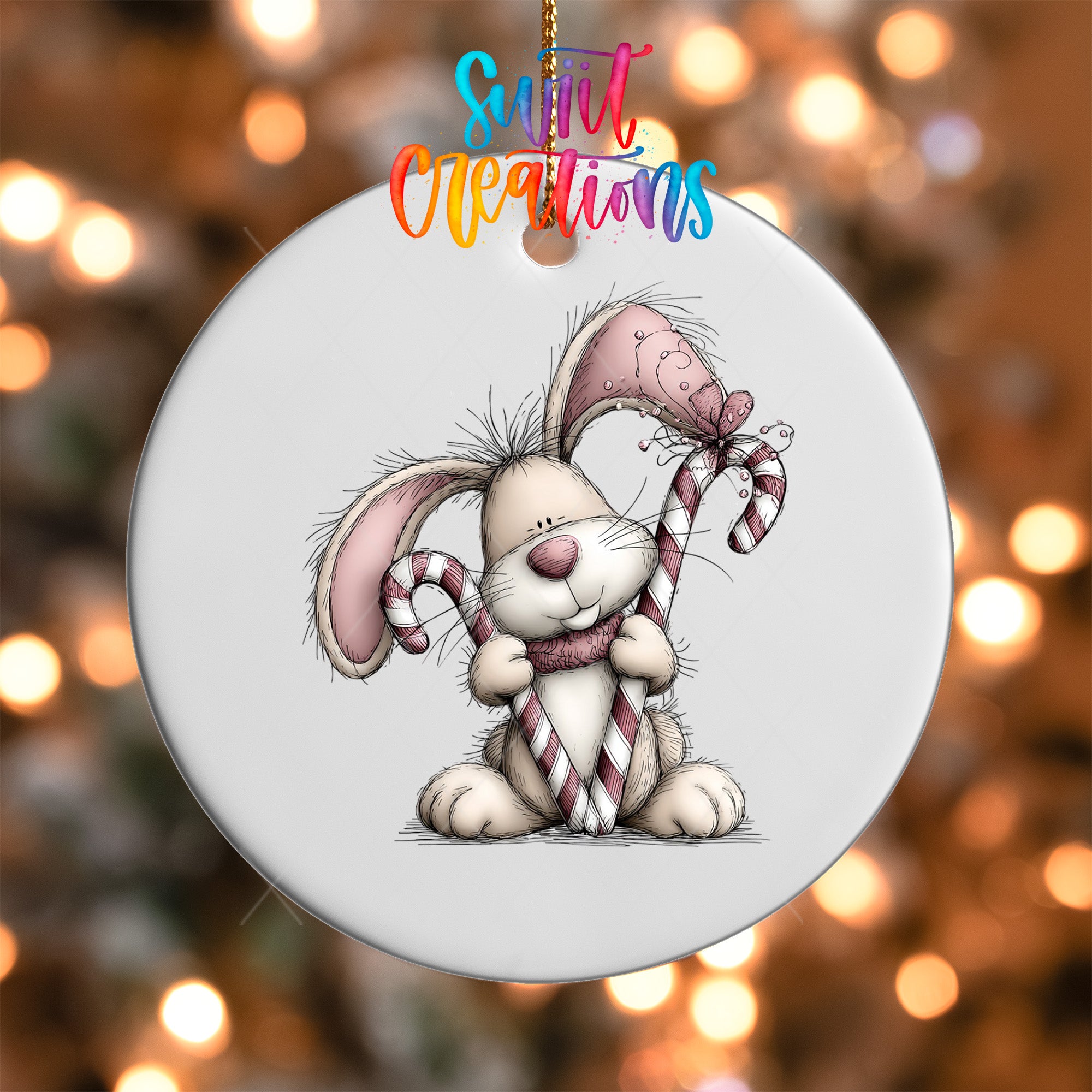 A white ceramic ornament featuring a cartoon rabbit holding candy canes and a bow.