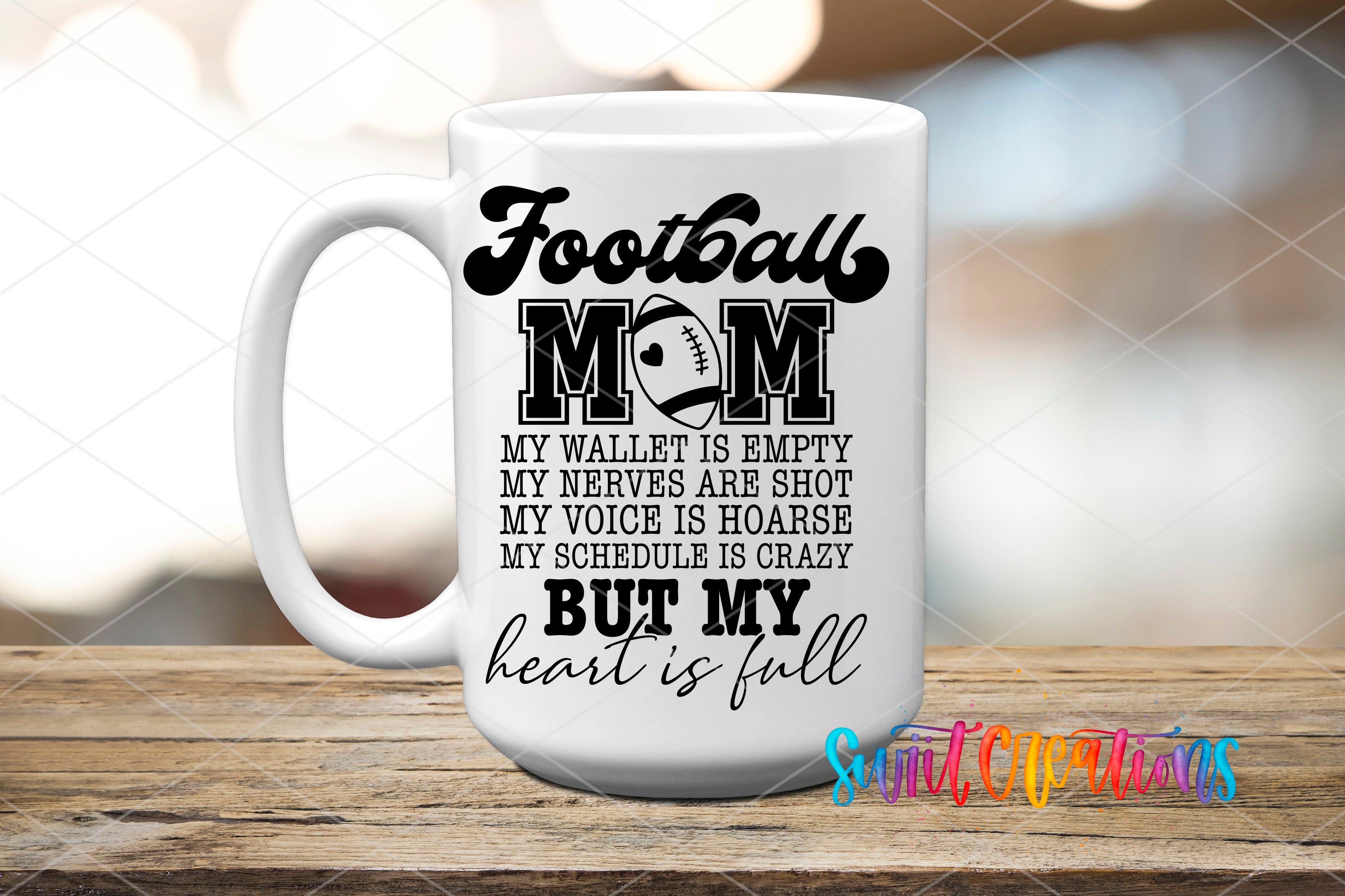 A white ceramic mug with black text and graphics that reads "Football Mom" and "My wallet is empty, my nerves are shot, my voice is hoarse, my schedule is crazy, but my heart is full".