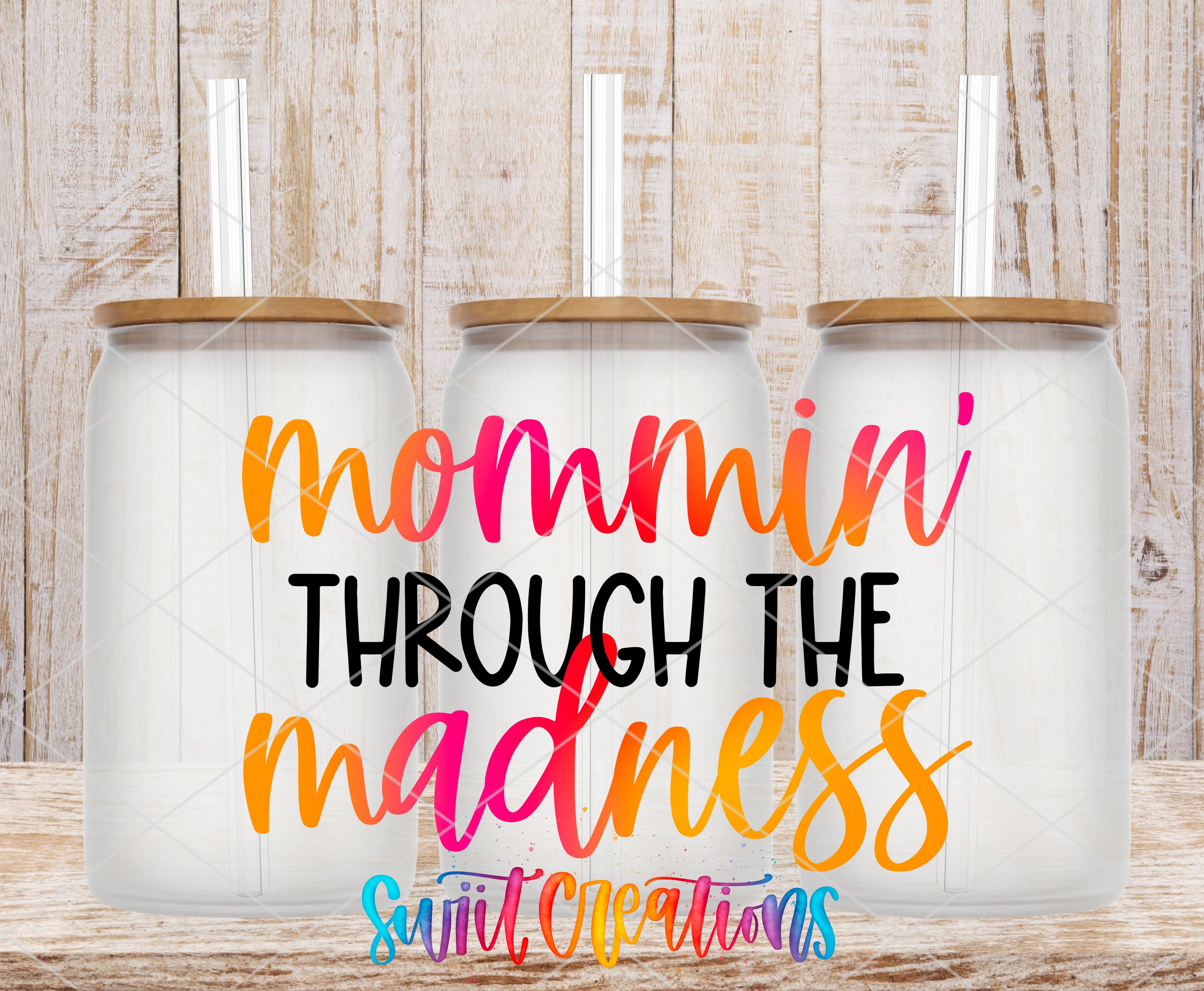 three glass jars with lids, arranged in a row against a wooden background. The text "mommini through the madness" is displayed prominently in the center of the image.