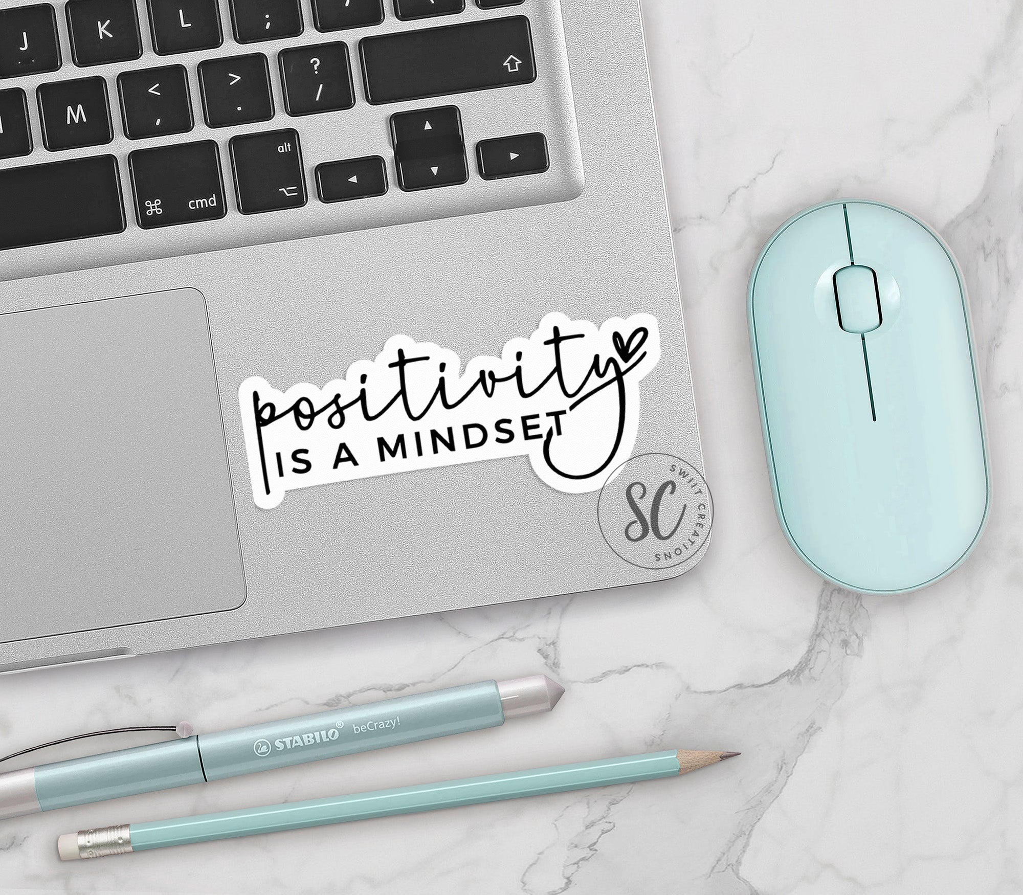 a laptop with a sticker that says positive is a mindset