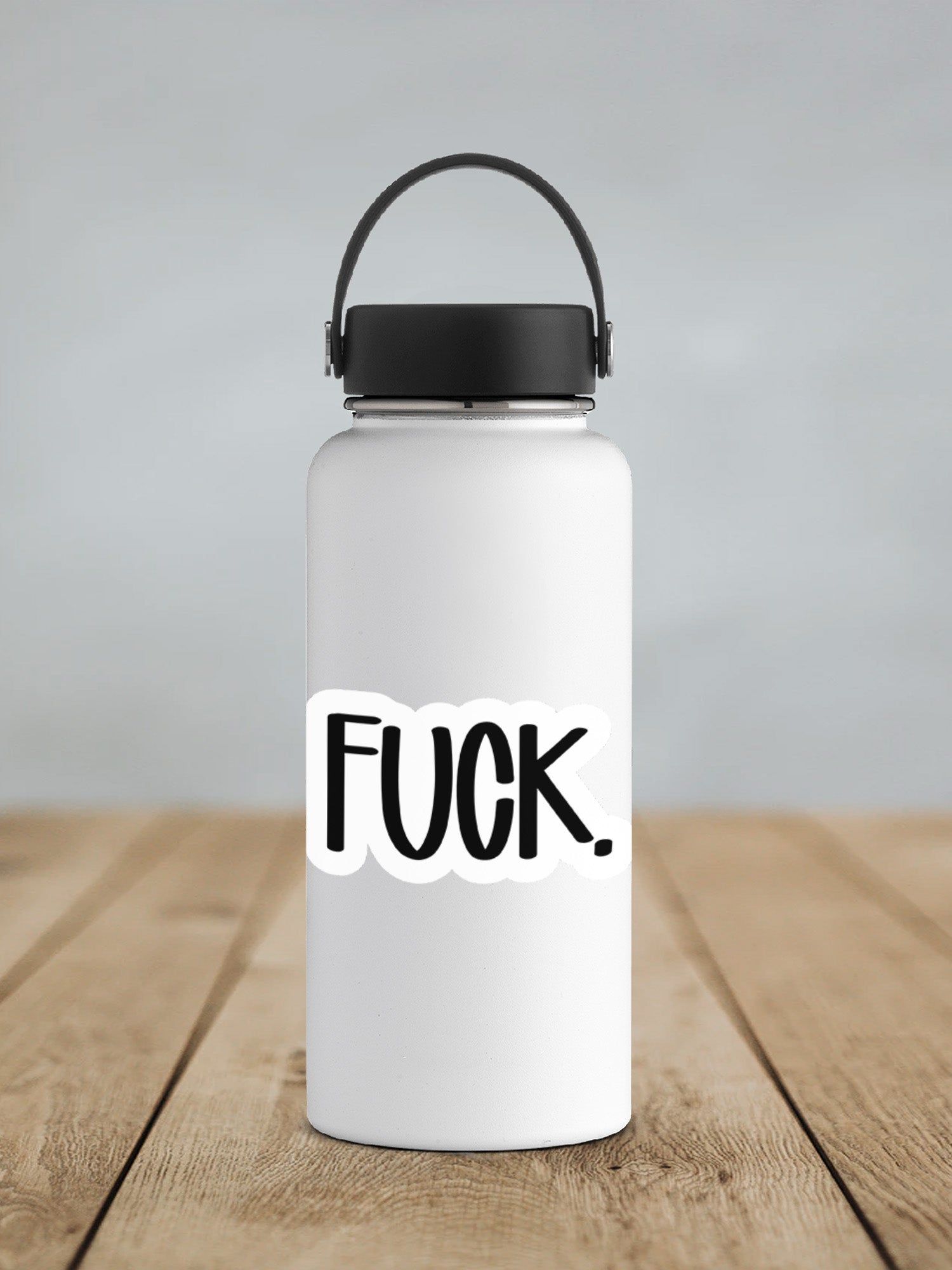 a white water bottle sitting on top of a wooden table