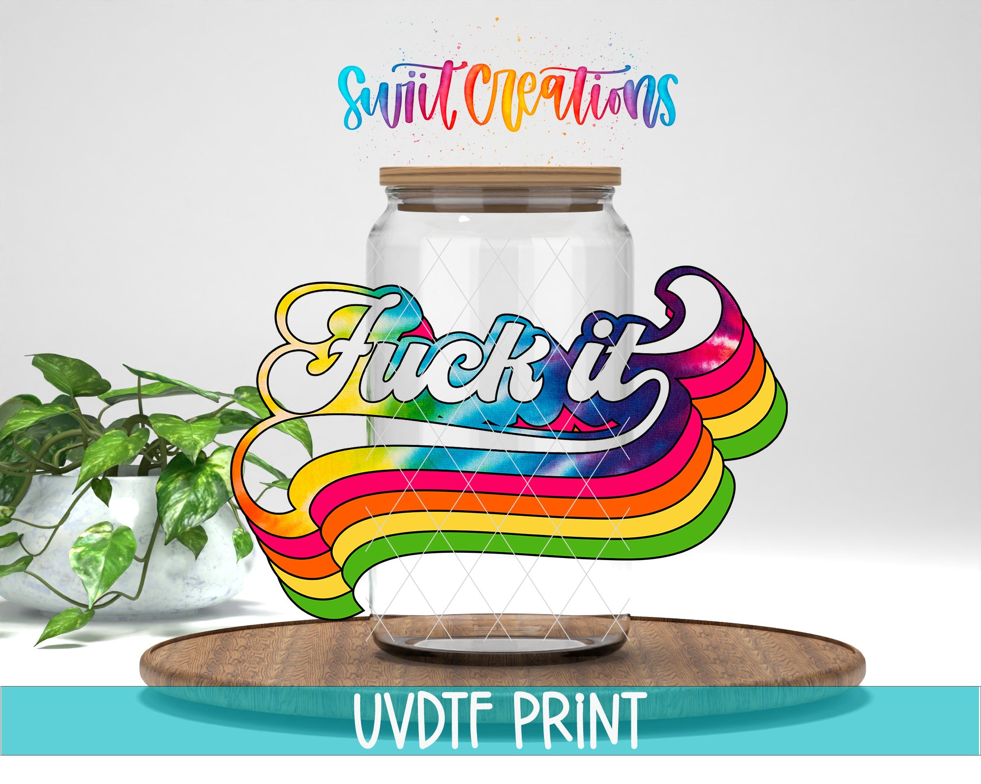 a large glass jar with a colorful, rainbow-colored design on it, along with the text "FUCK IT" written on it. The jar is placed on a wooden surface, and there is a plant in the background.
