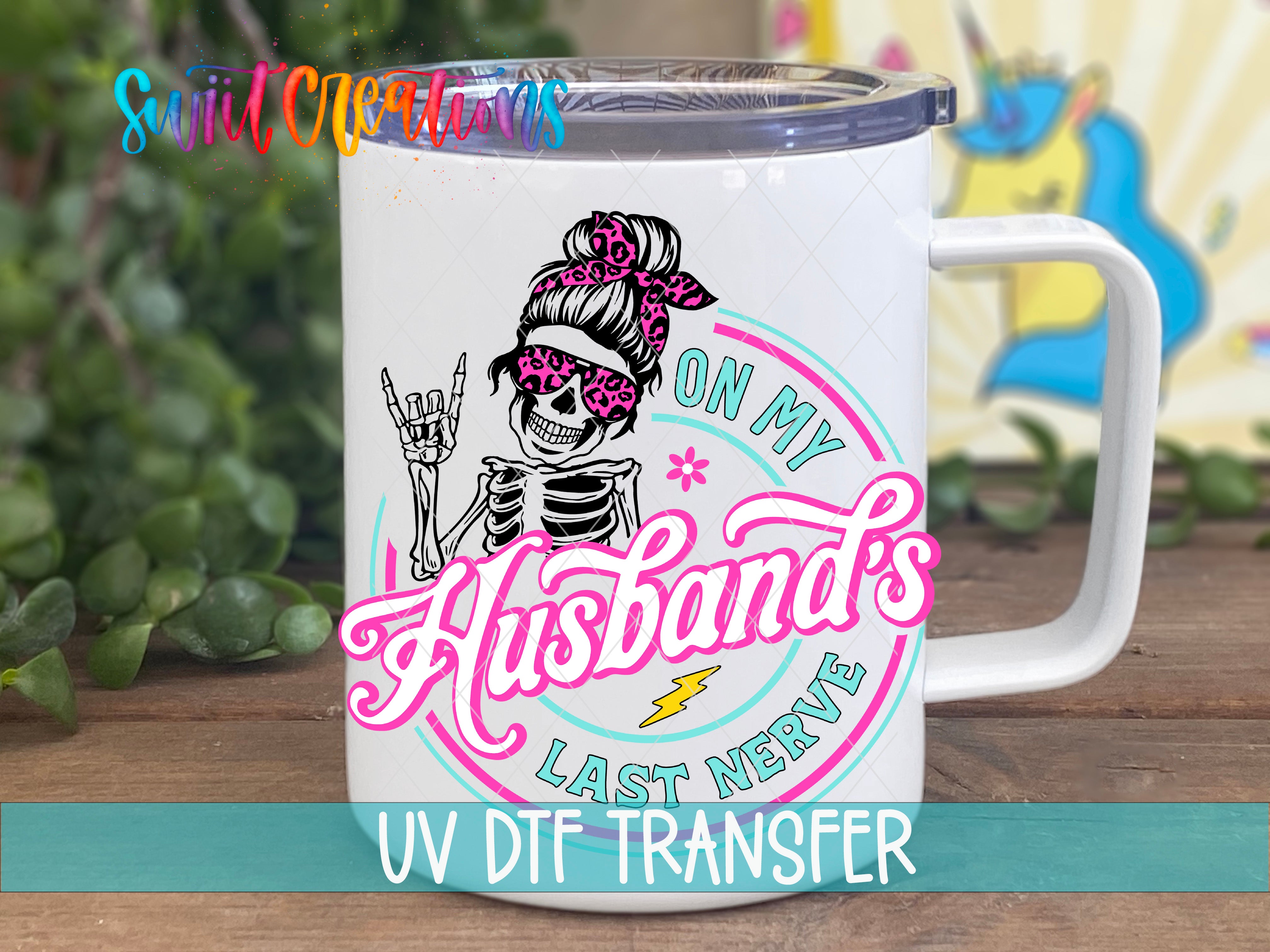 A white mug with a colorful graphic design featuring a skeleton wearing sunglasses and the text "On My Husband's Last Nerve" printed on it.