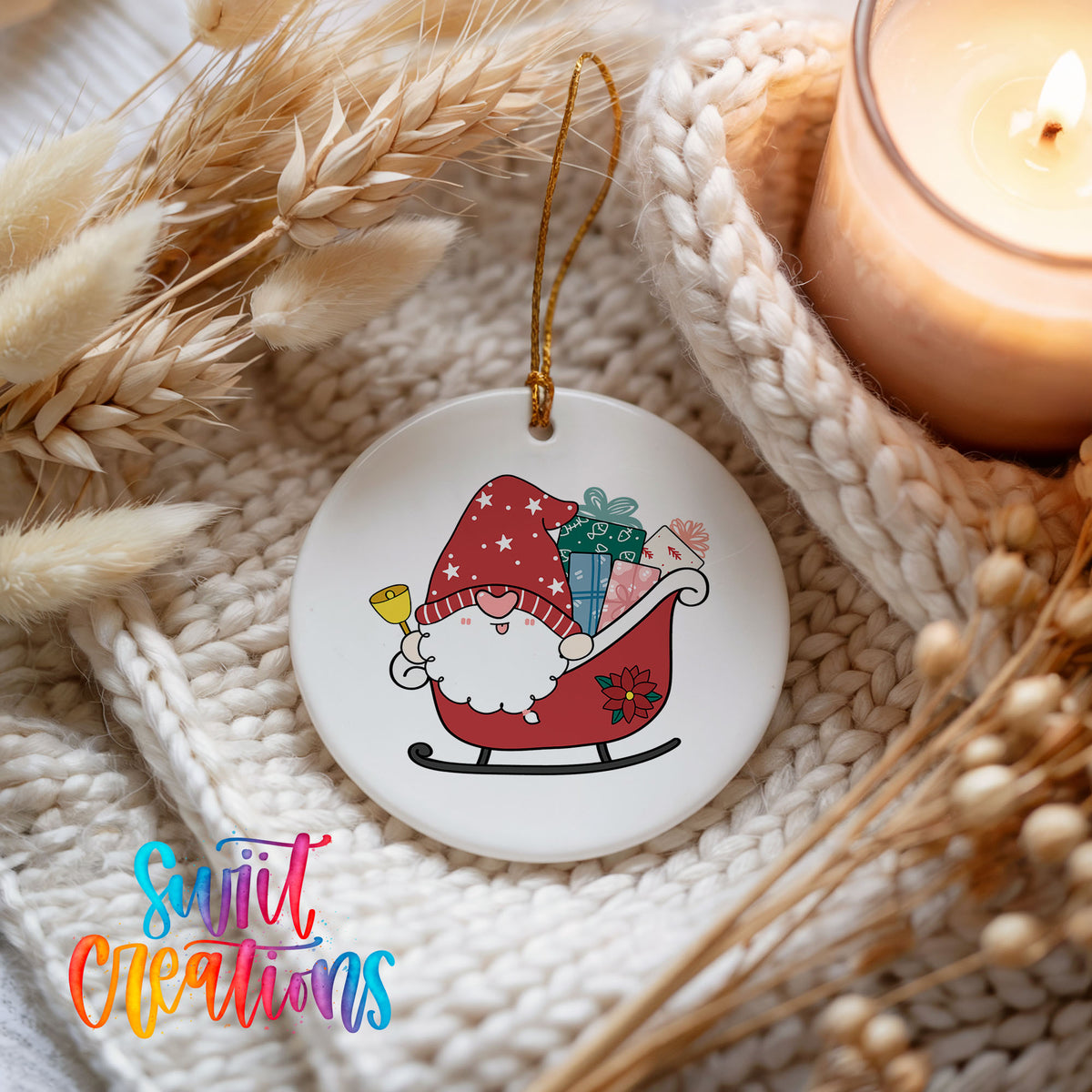 A ceramic ornament featuring a gnome riding a sleigh, with a candle and dried flowers in the background.