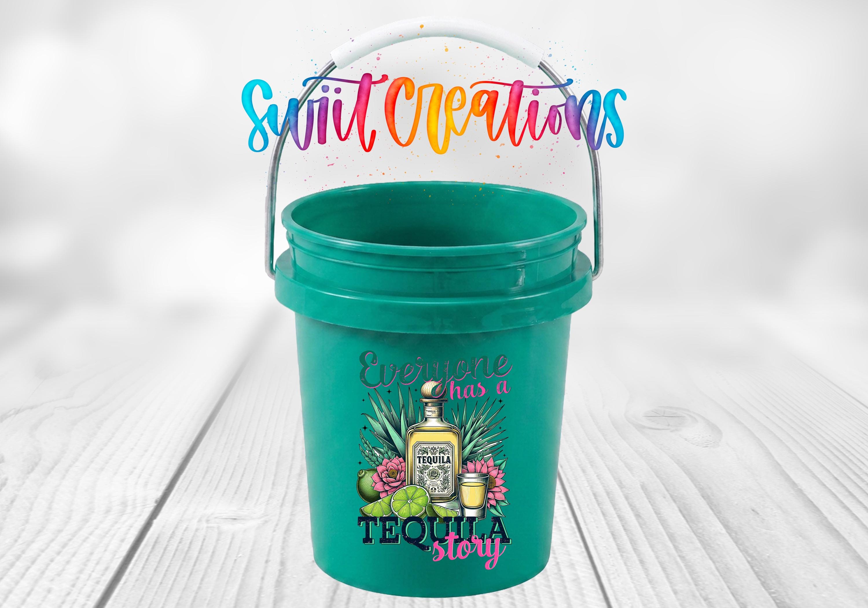 A green plastic bucket with a colorful design featuring a tequila bottle and various tequila-related items, along with the text "Everyone has a TEQUILA STORY".