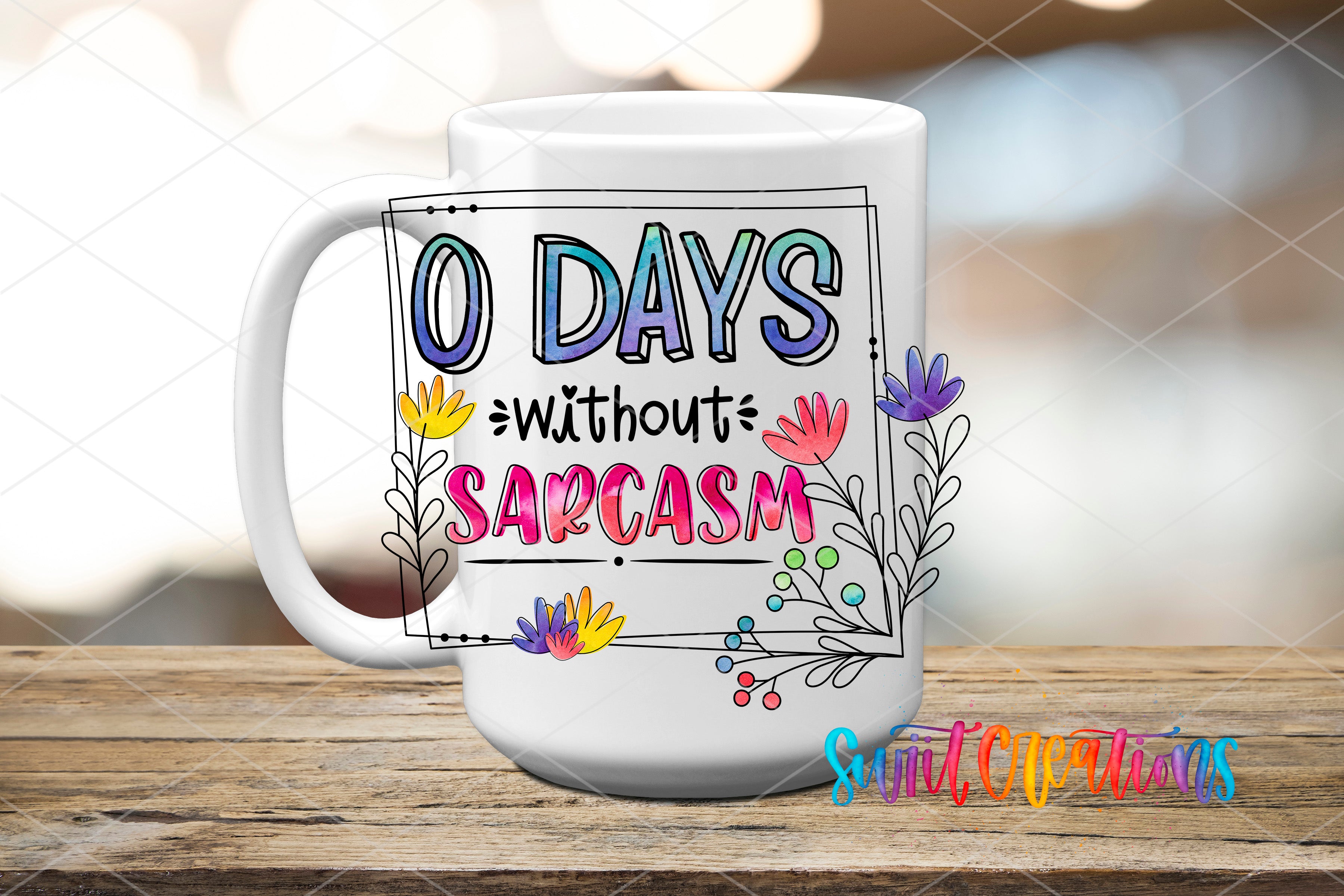 A white mug with a colorful design and text on it, placed on a wooden surface.