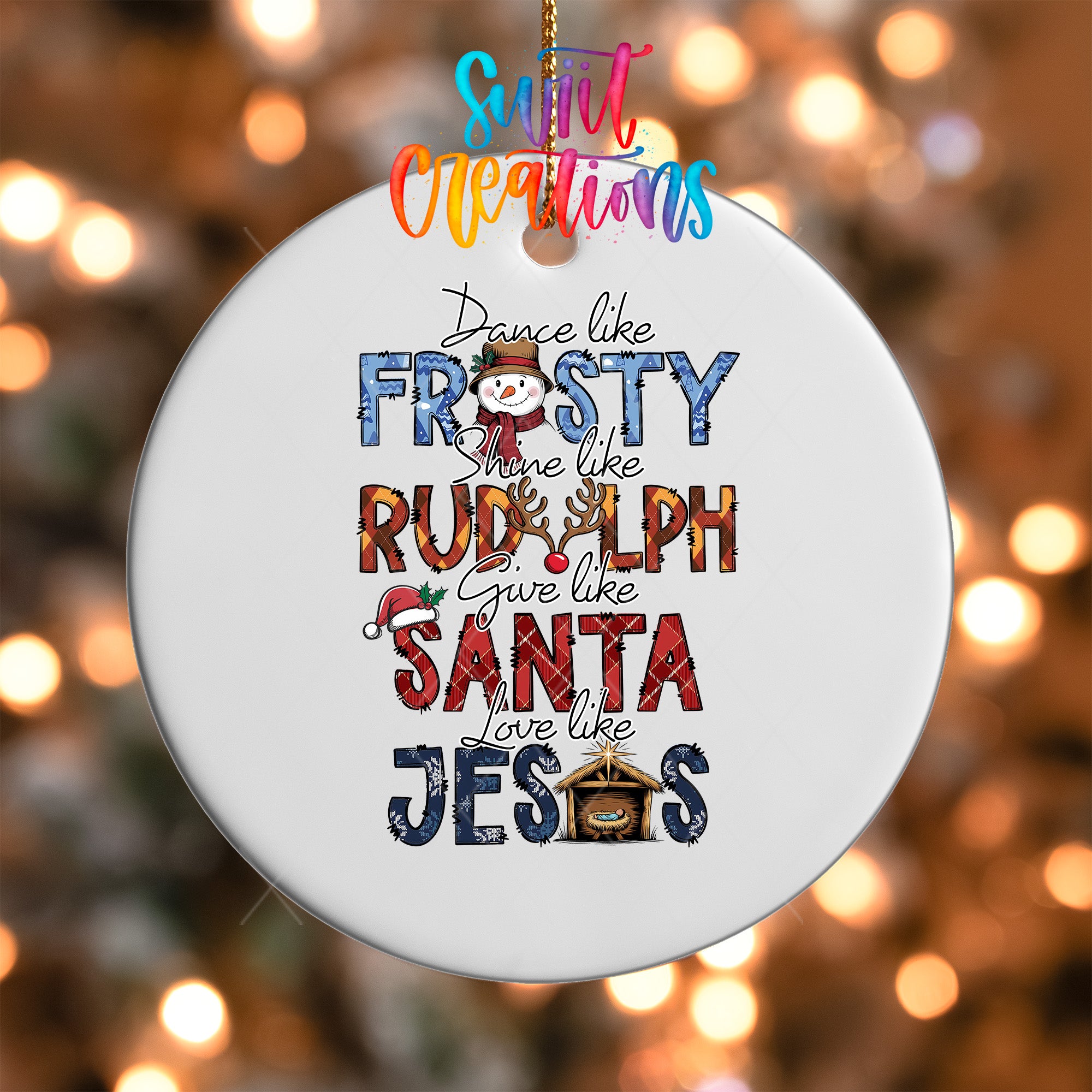 A white ceramic ornament with colorful text and a snowman design, hanging against a blurred background with twinkling lights.