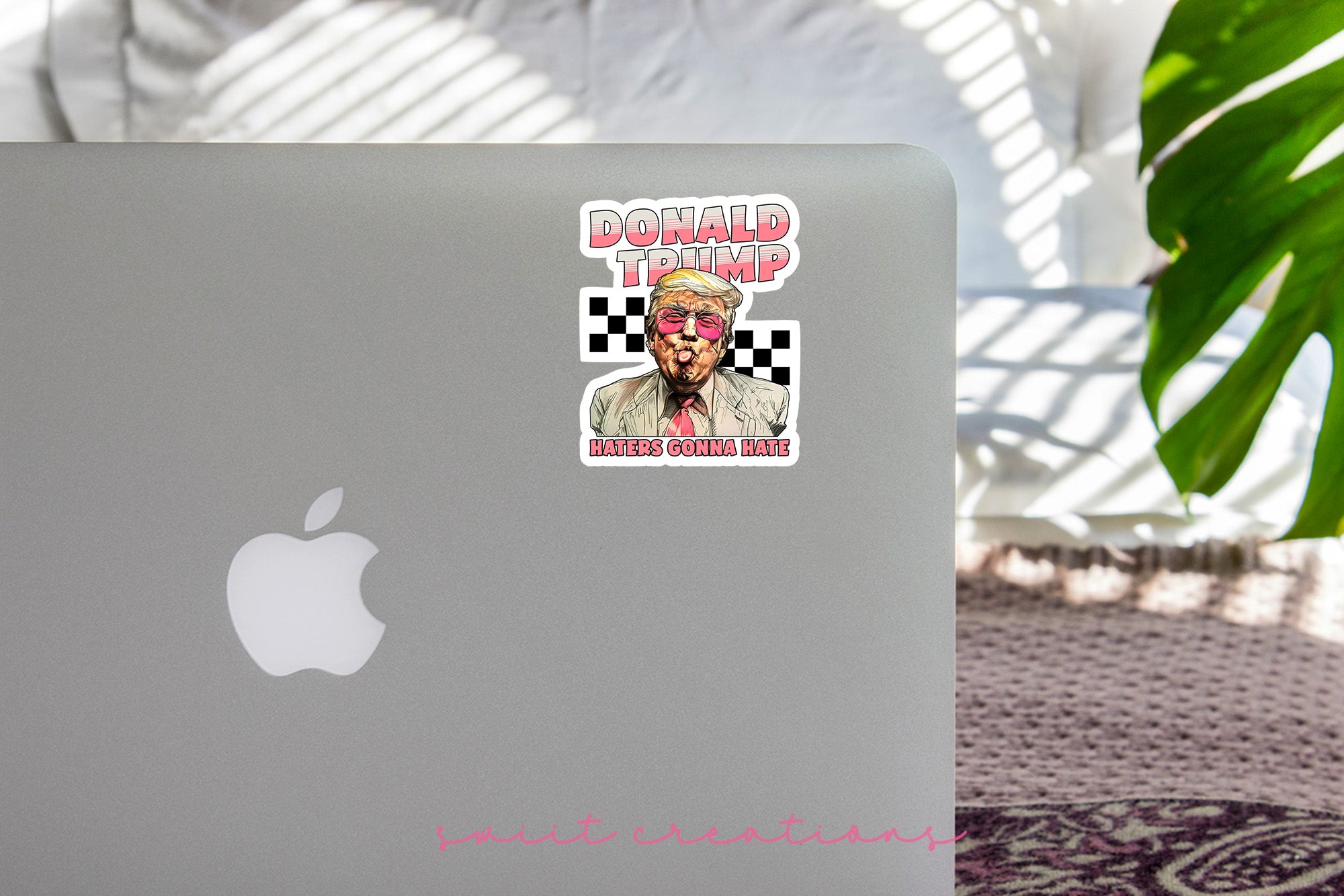 a laptop with a sticker of donald trump on it
