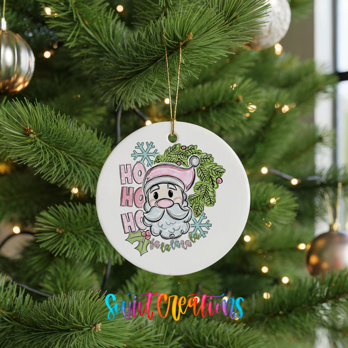 A white Christmas tree ornament with a cartoon Santa Claus and the text "HOOK HOOK HOOK" hanging from a tree branch.