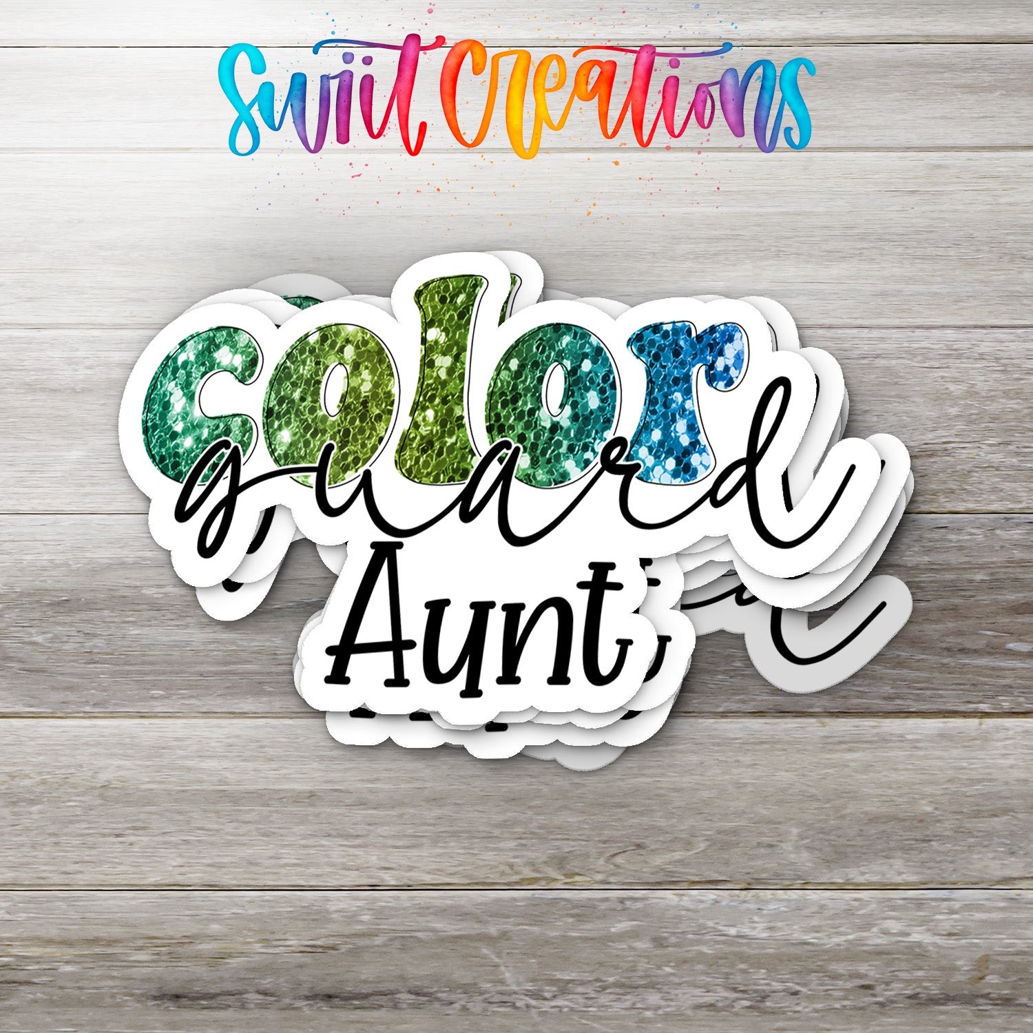 A colorful sticker design with the text "Color guard Aunt" on a wooden background.