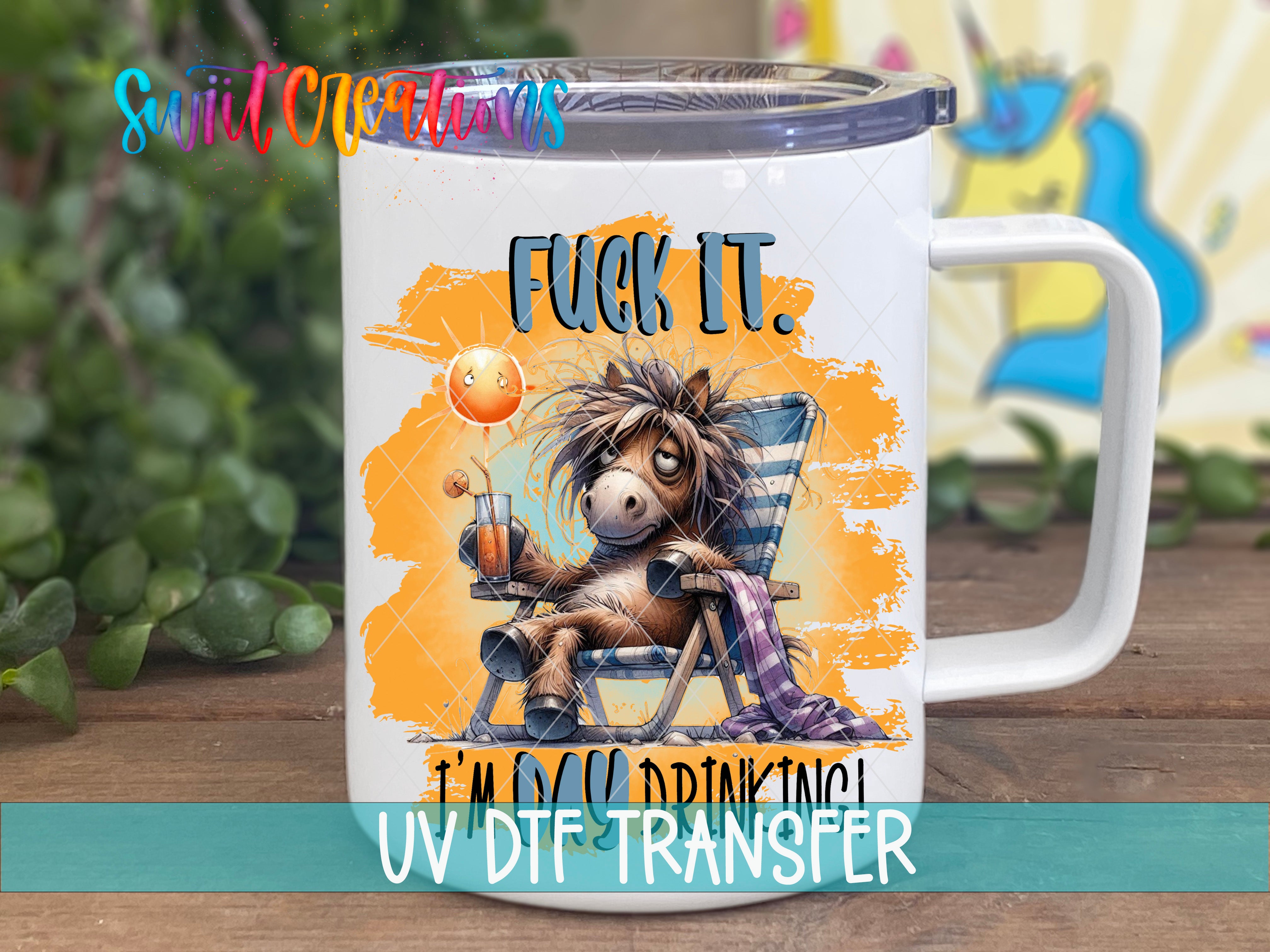 A mug with a cartoon image of a horse sitting in a chair, holding a drink, and the text "FUCK IT" and "I'M DRINKING" printed on it.