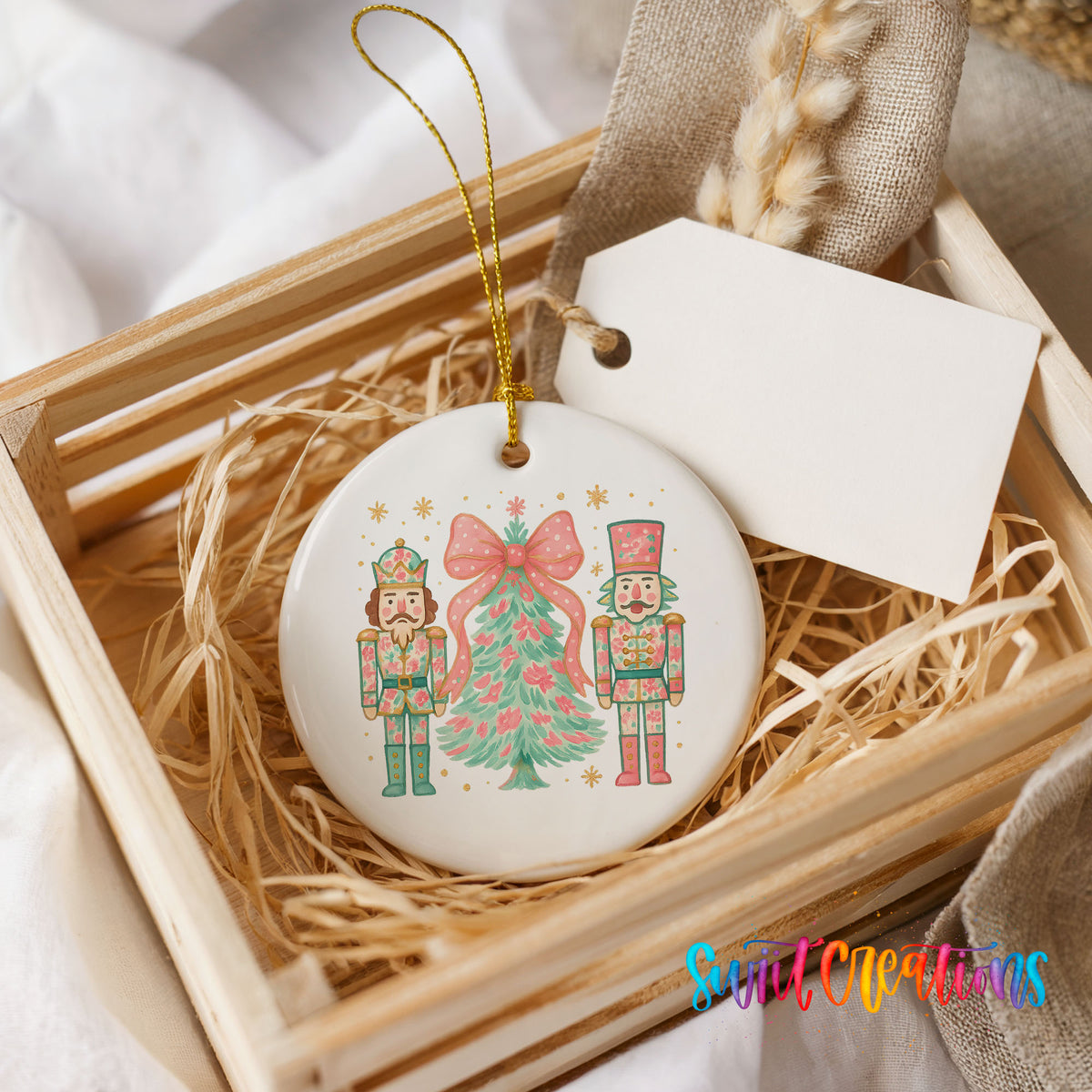 A wooden crate containing a white ceramic ornament with a nutcracker and a Christmas tree design.