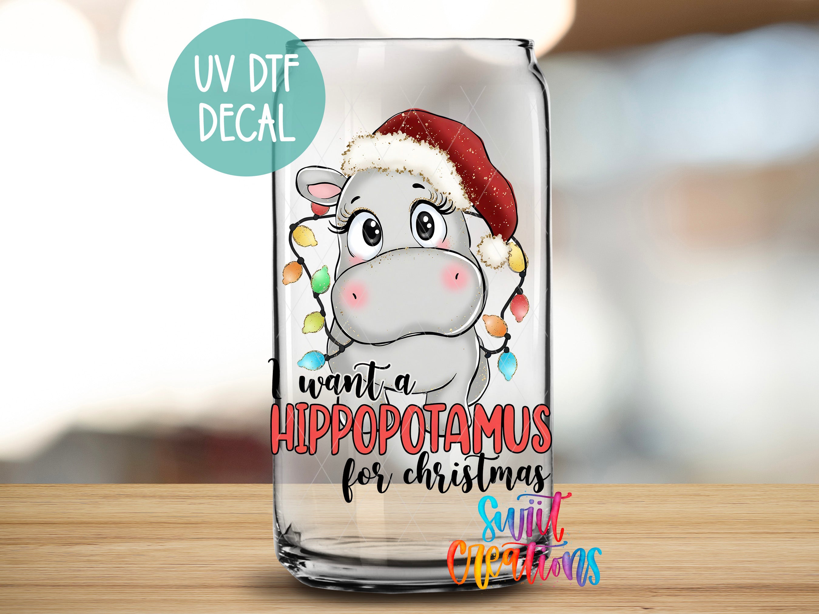 A glass can with a cartoon image of a hippopotamus wearing a Santa hat and the text "I want a Hippopotamus for Christmas" printed on it.