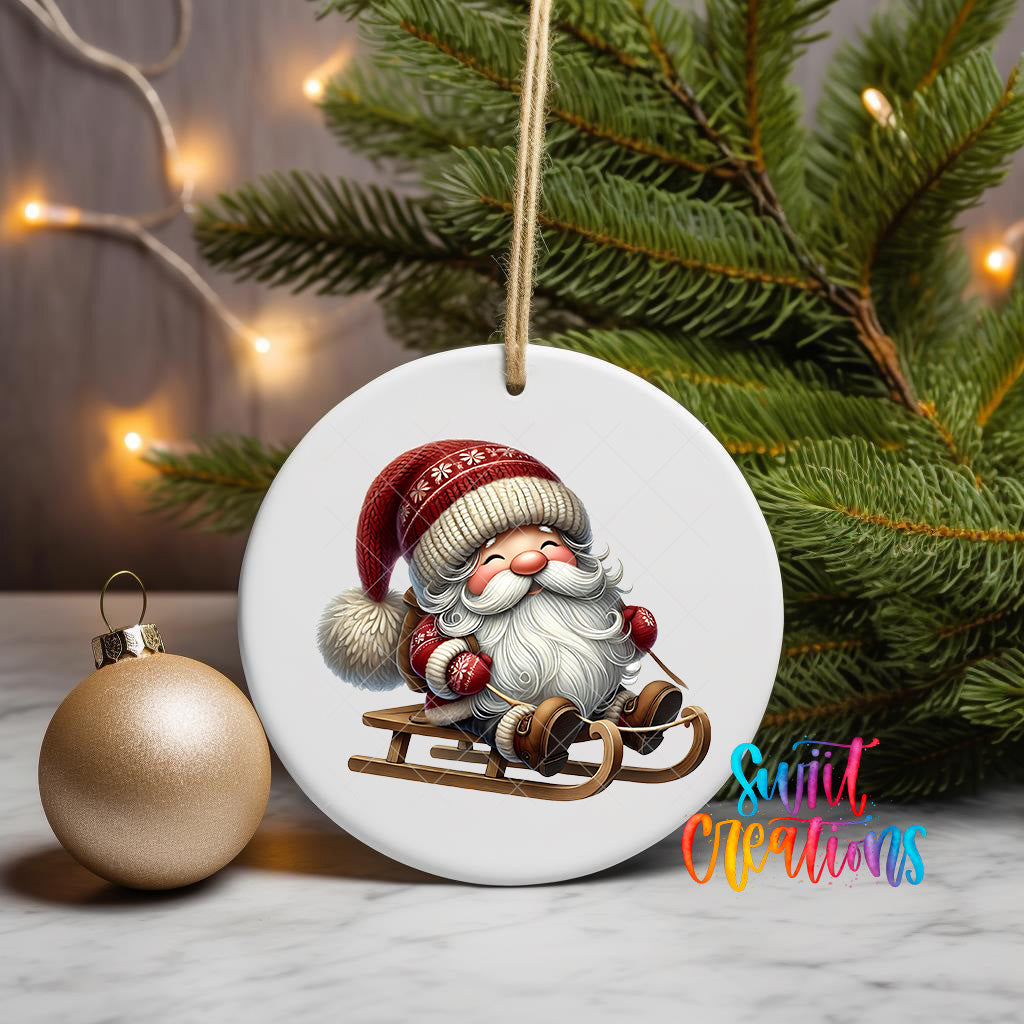A white ornament featuring a smiling gnome riding a sled, surrounded by a Christmas tree and twinkling lights.