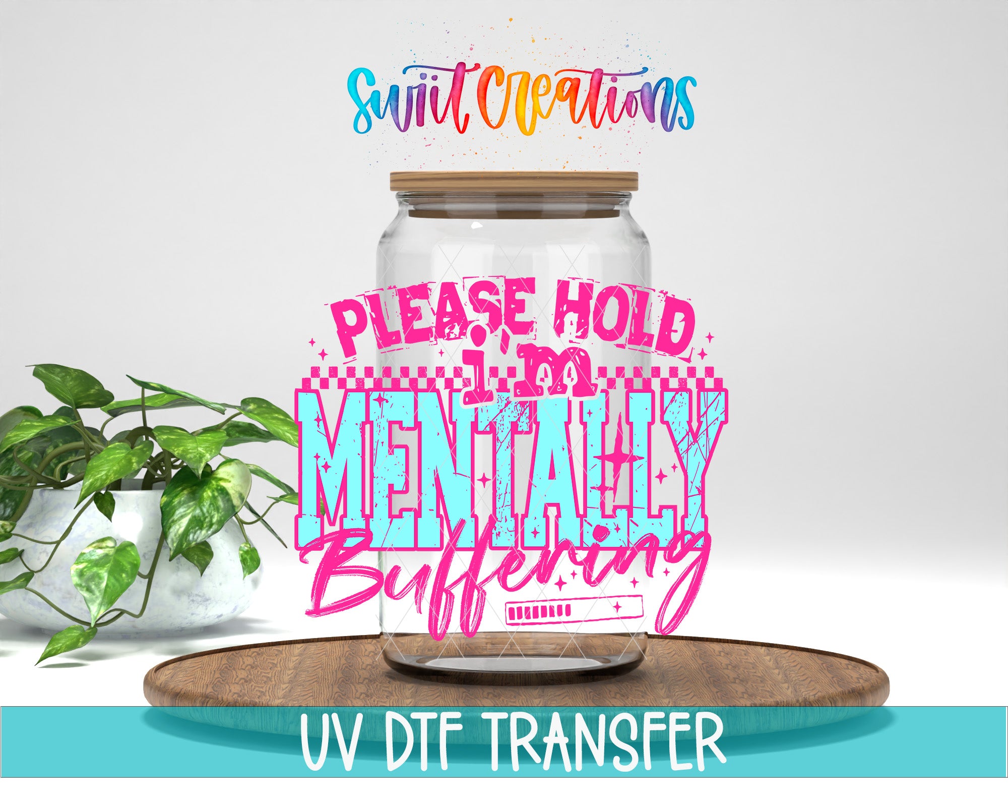 a large glass jar with a wooden lid, placed on a wooden surface. The jar has a message written on it in a colorful, stylized font that says "Please hold mentally buffering". There is also text at the bottom of the image that says "UV DFT TRANSFER".