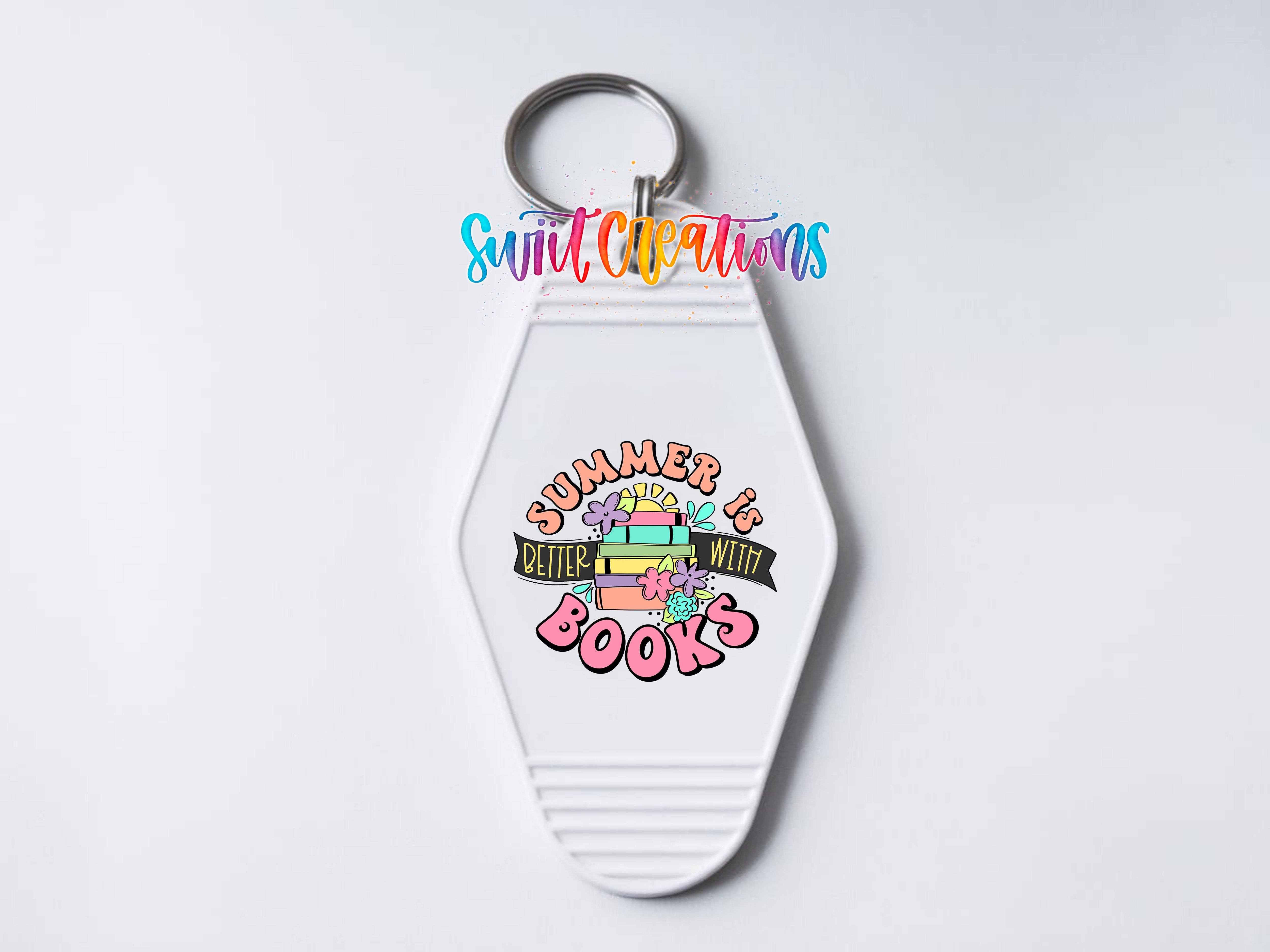 A keychain with a colorful design featuring a stack of books and the text "Summer is better with books"