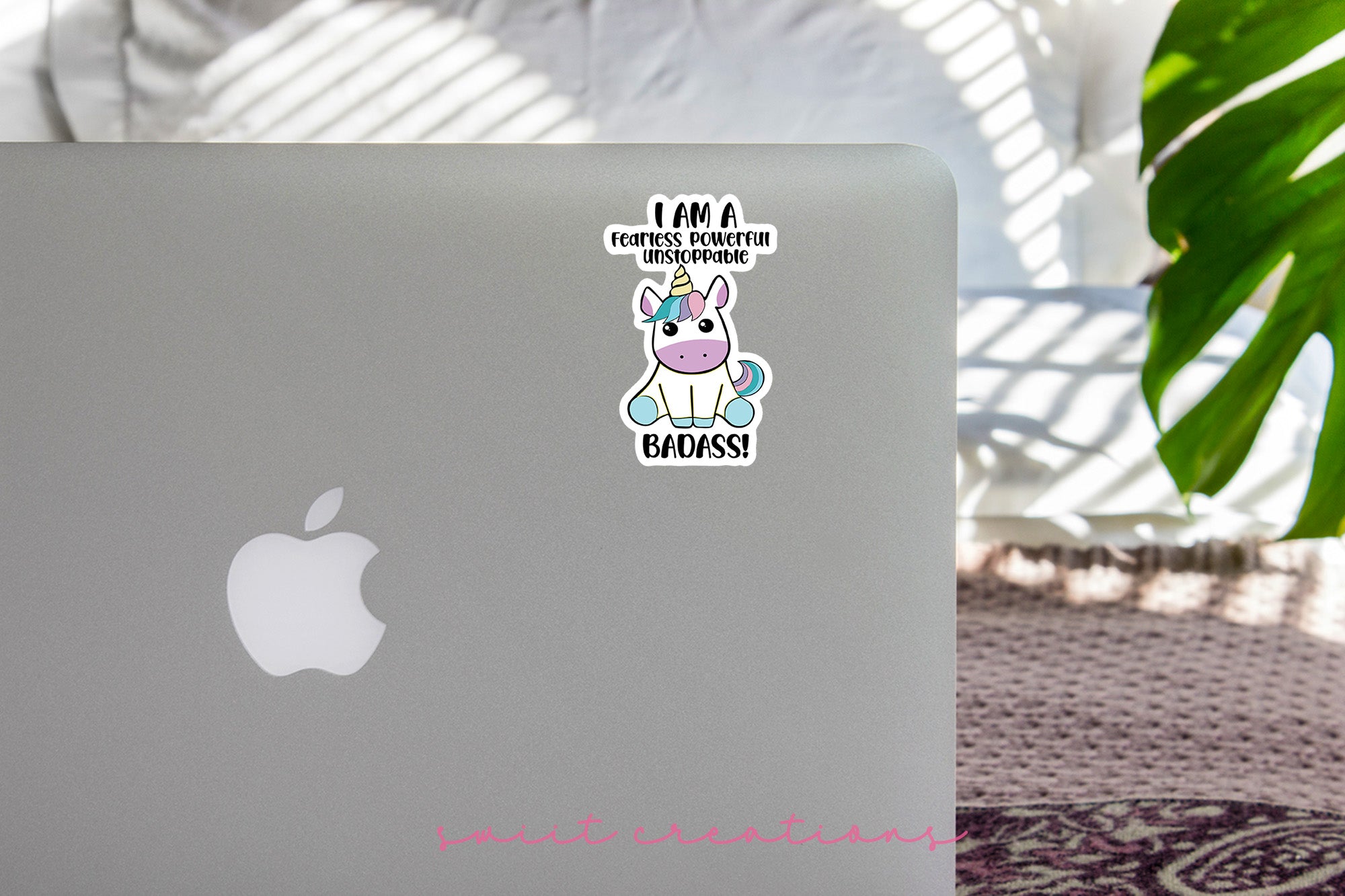 a laptop with a sticker of a unicorn on it