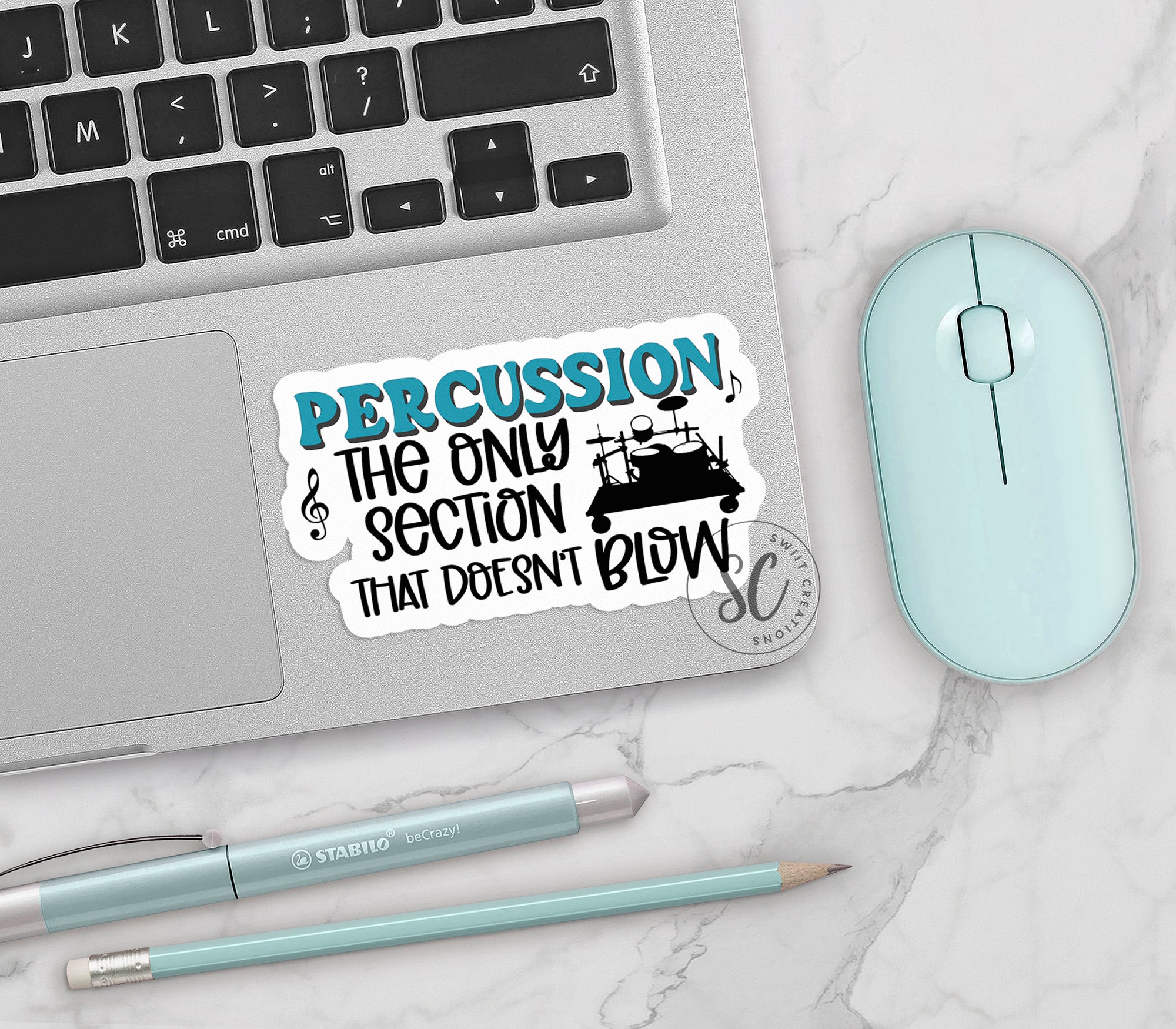 a laptop with a sticker on it next to a mouse