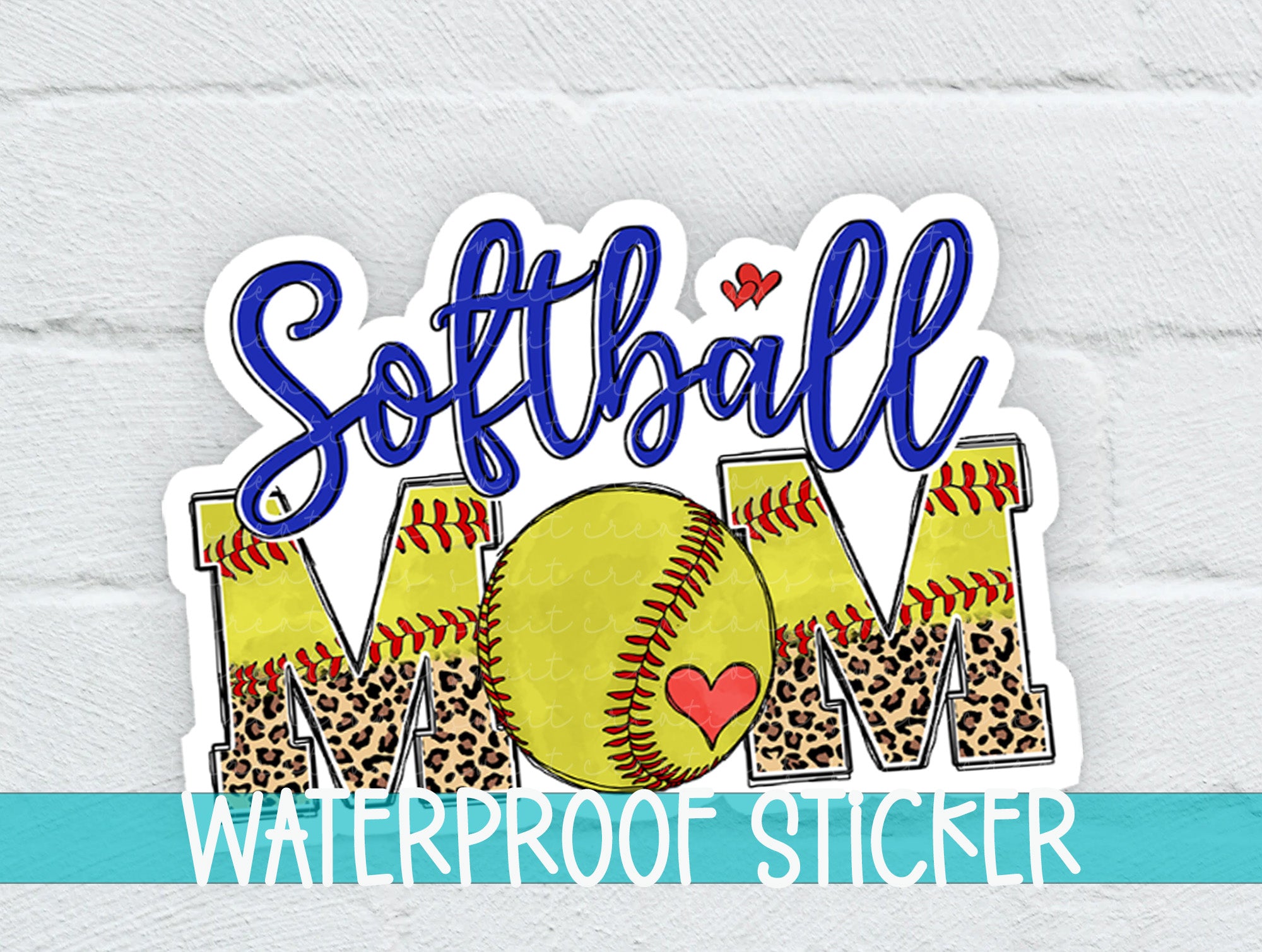 a softball mom sticker on a white brick wall
