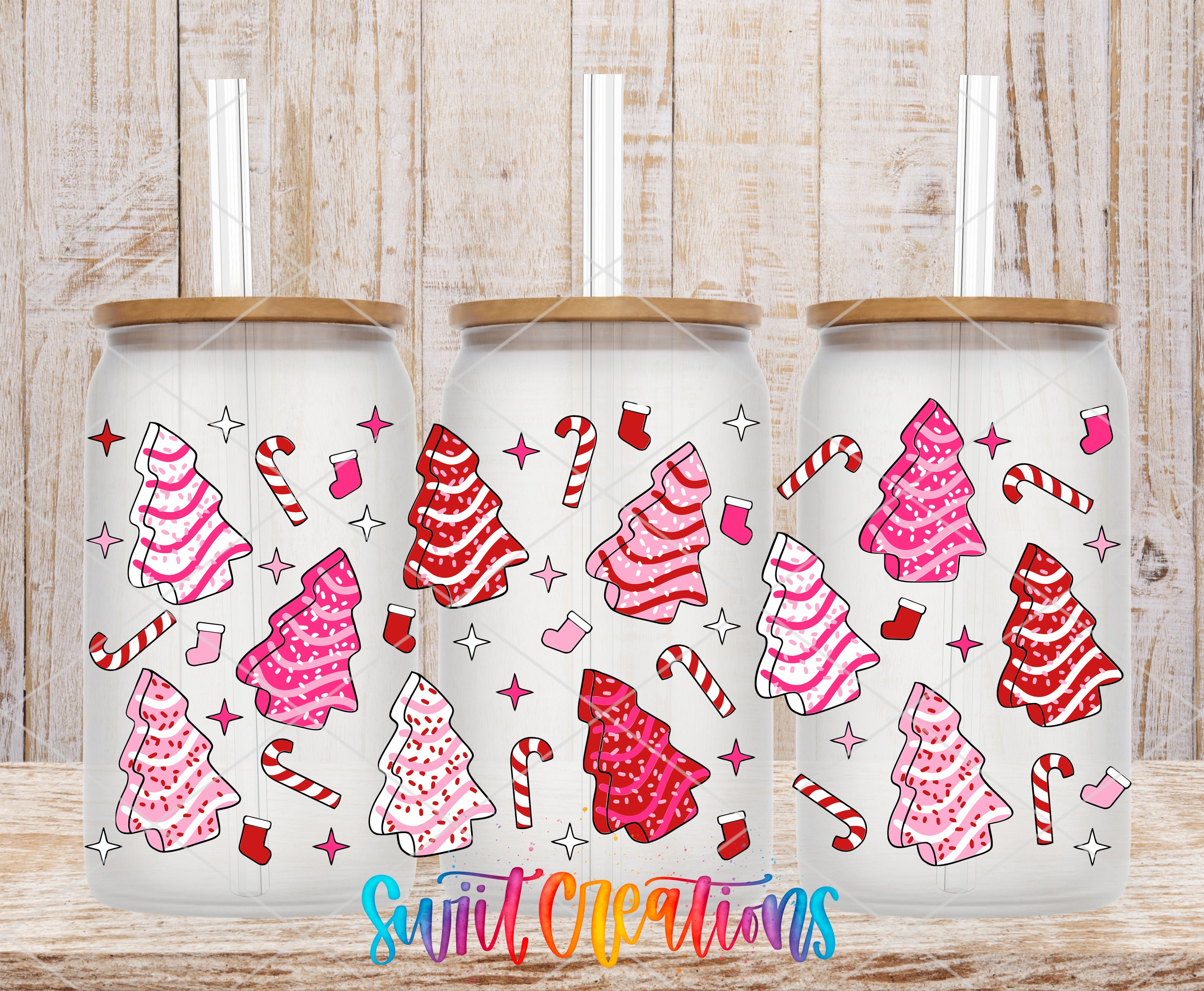 Three glass tumblers with a festive Christmas tree and candy canes design, placed on a wooden surface.