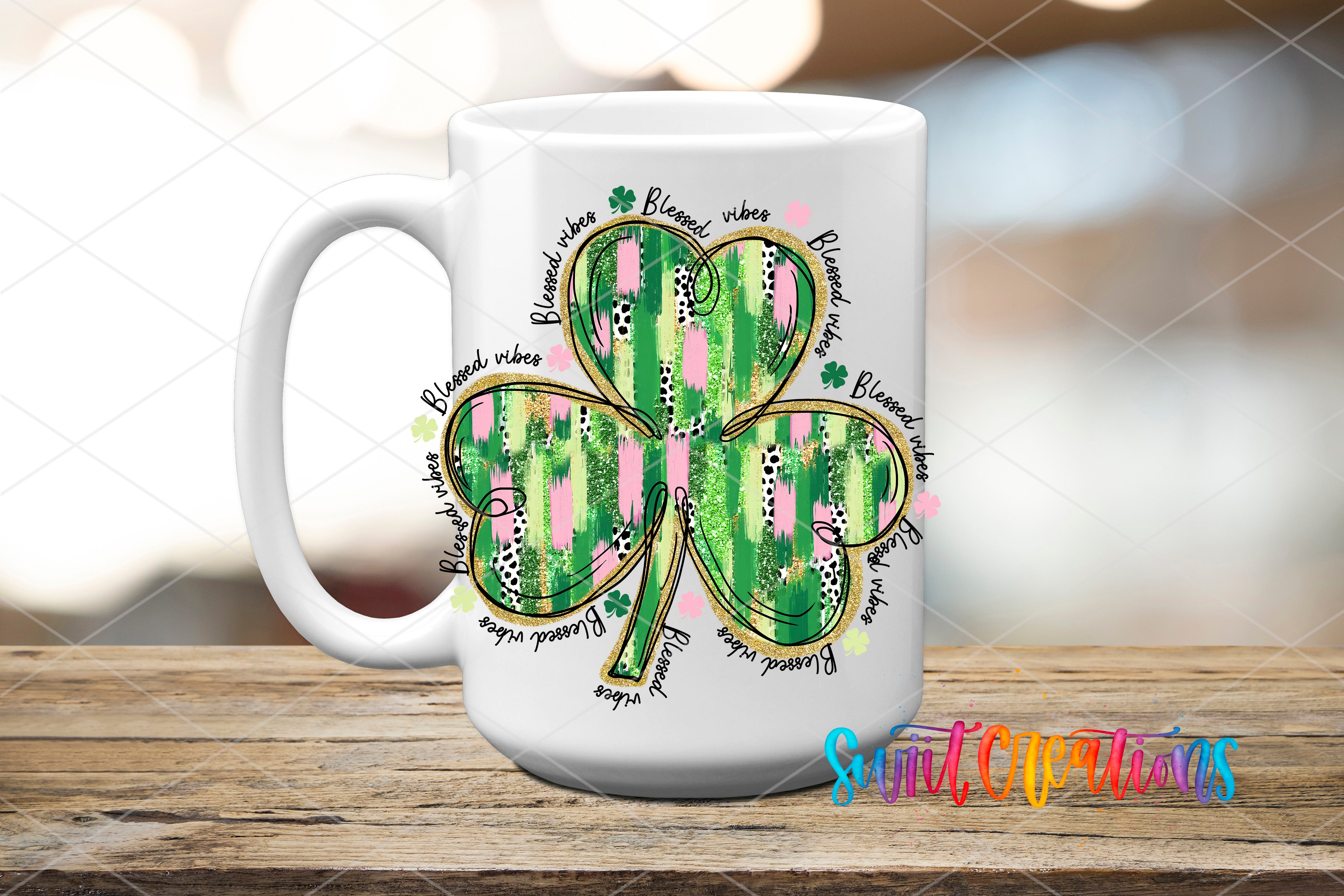 A white ceramic mug with a colorful design featuring a clover with green and pink stripes, surrounded by the words "Blessed are those who" in a stylized font.