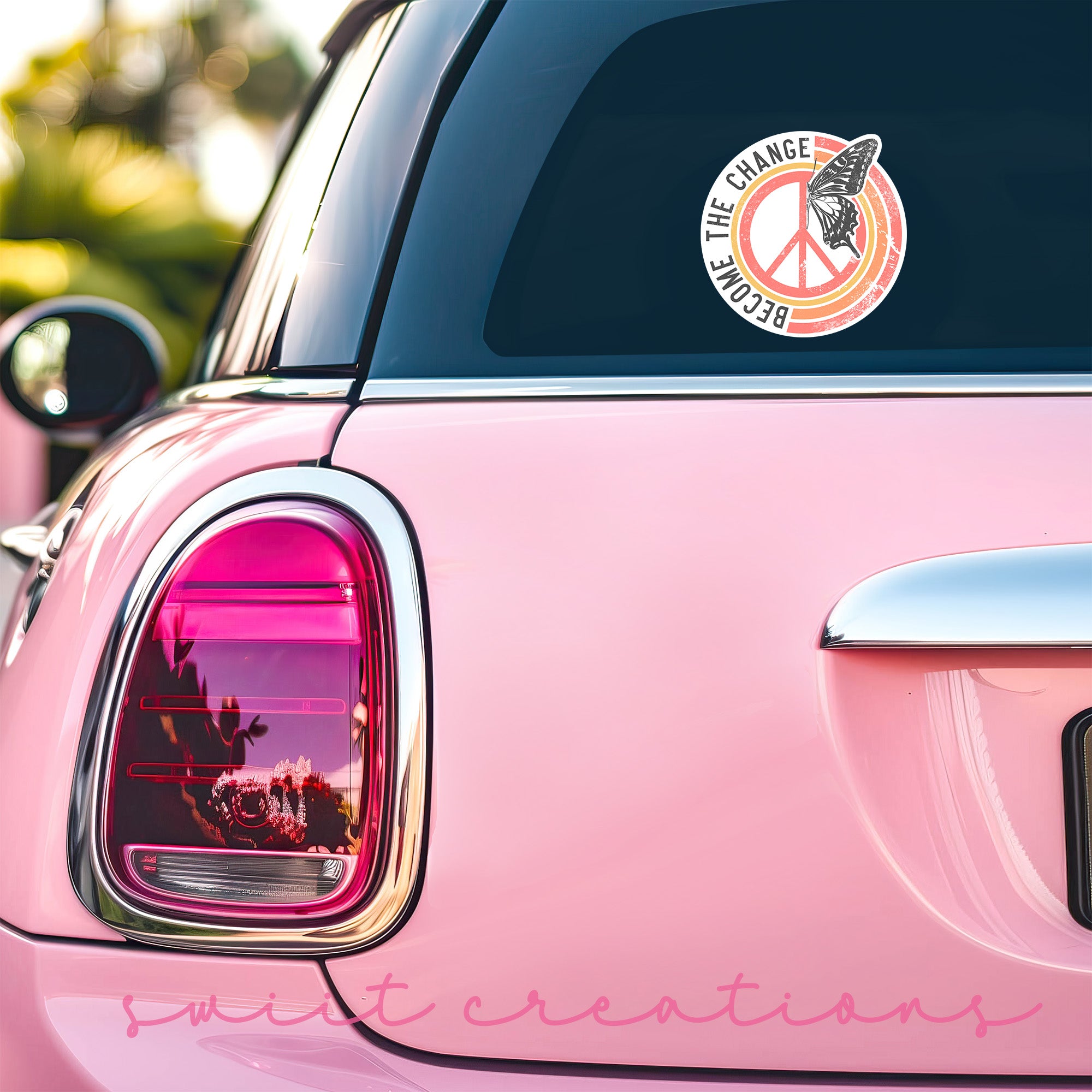 a pink car with a peace sign sticker on it