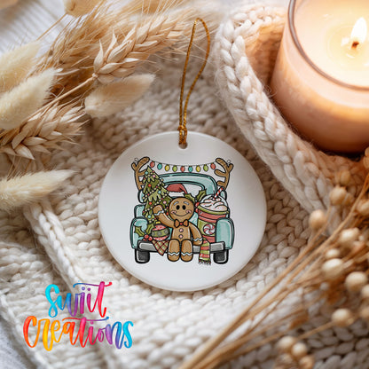A white ceramic ornament featuring a gingerbread man riding in a truck, surrounded by festive decorations such as a candle and dried flowers.