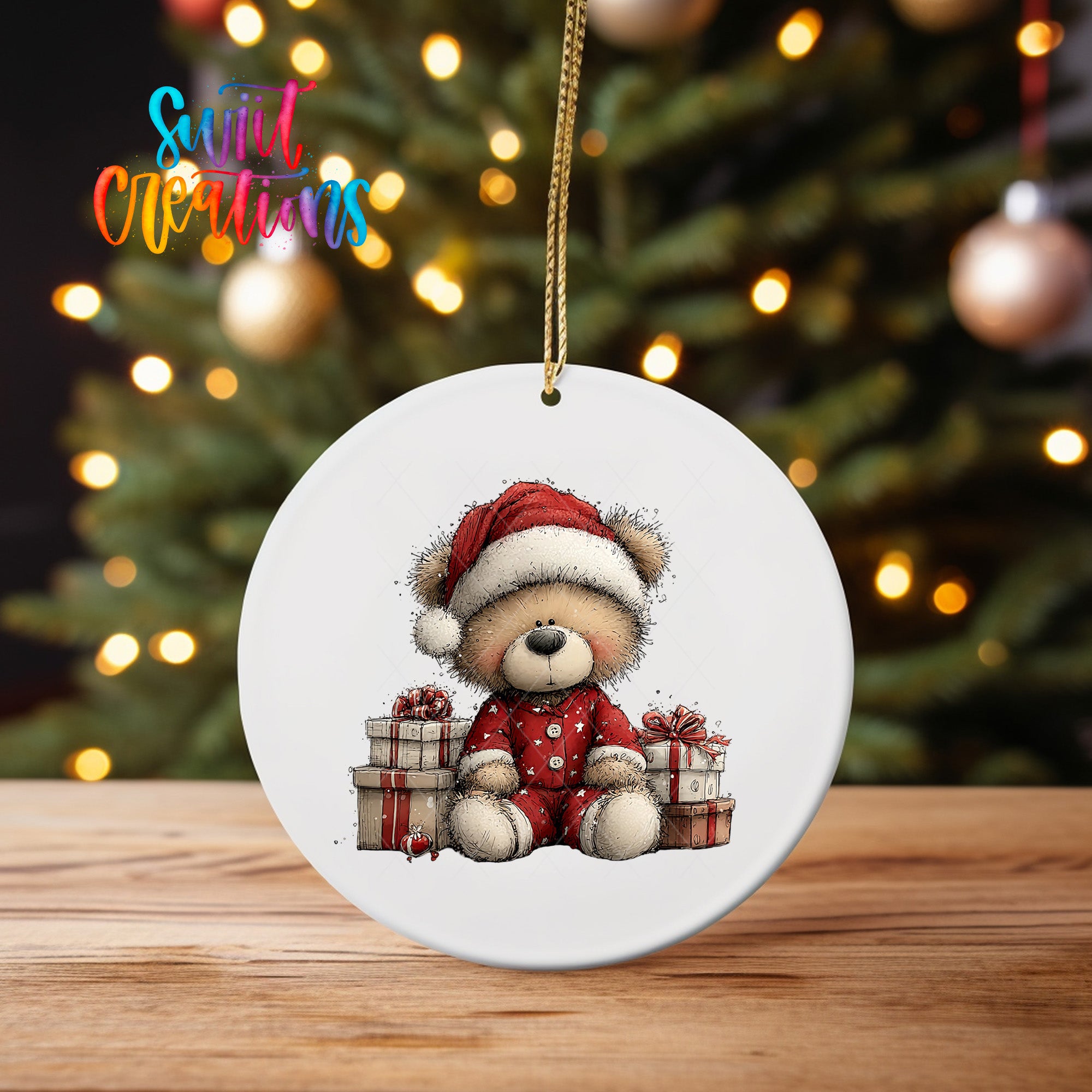 A white ceramic ornament featuring a teddy bear wearing a Santa hat and holding presents, sitting in front of a Christmas tree with twinkling lights in the background.
