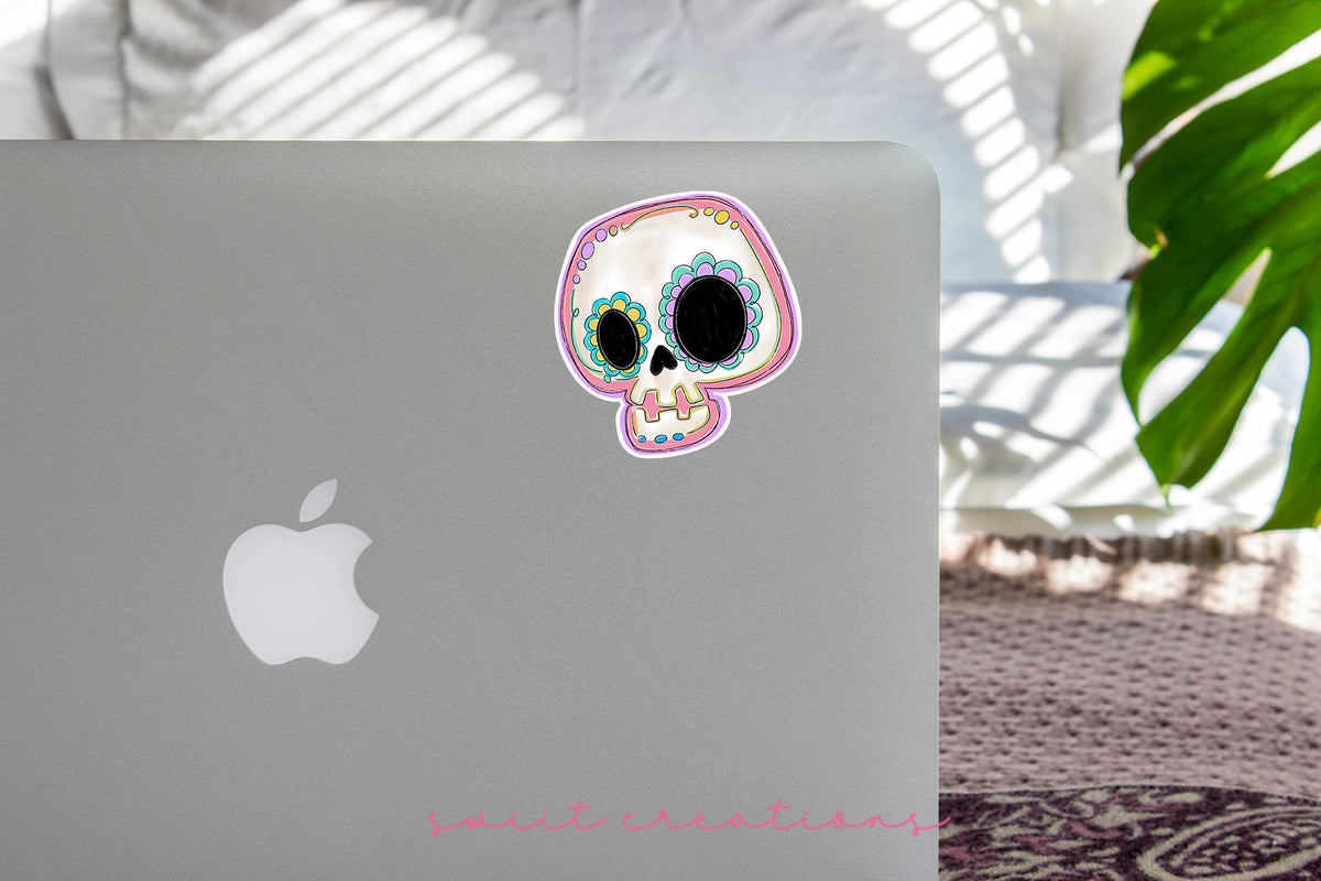 a laptop with a sticker of a skull on it