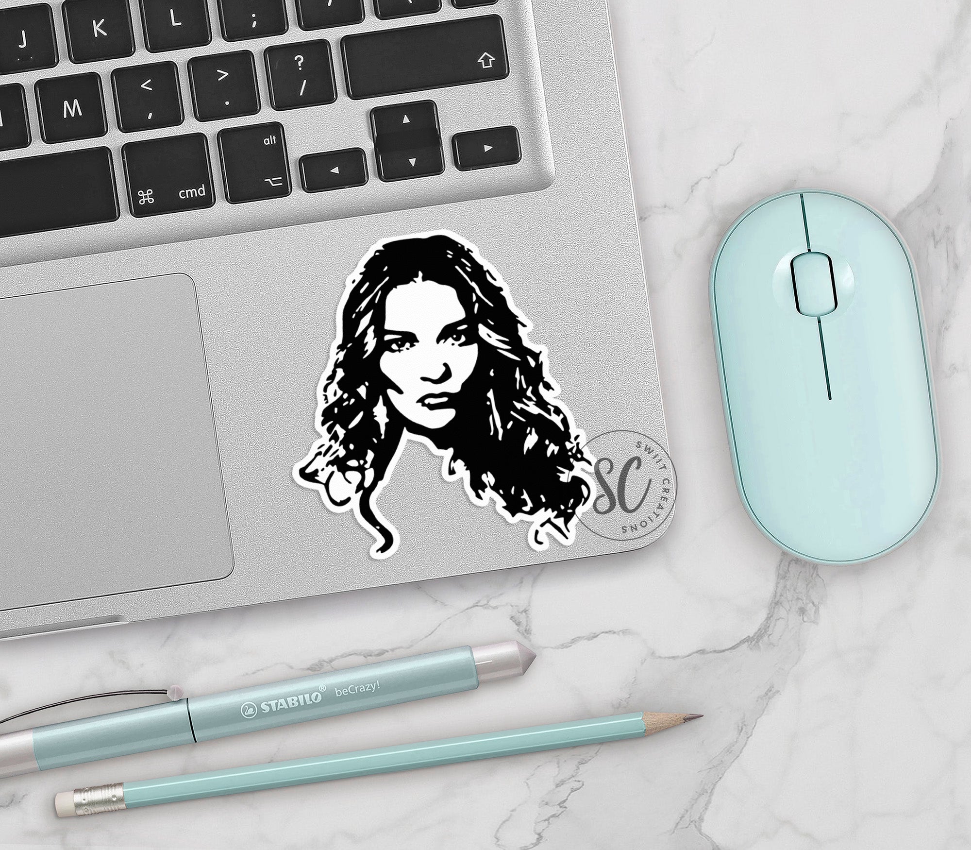 a laptop with a sticker of a woman's face