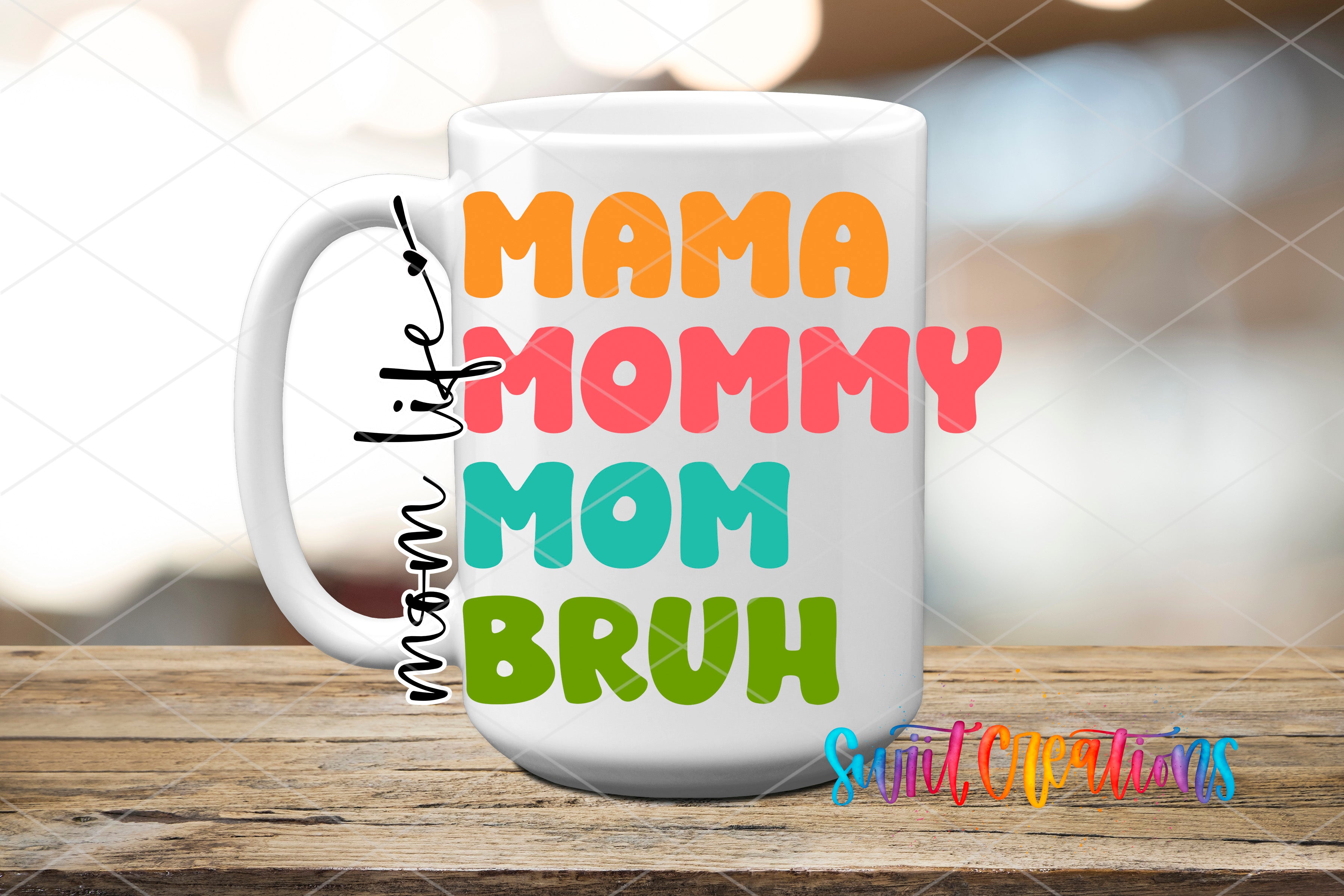 A white mug with colorful text that says "Mama Mommy Mom Bruh" on it, placed on a wooden surface.