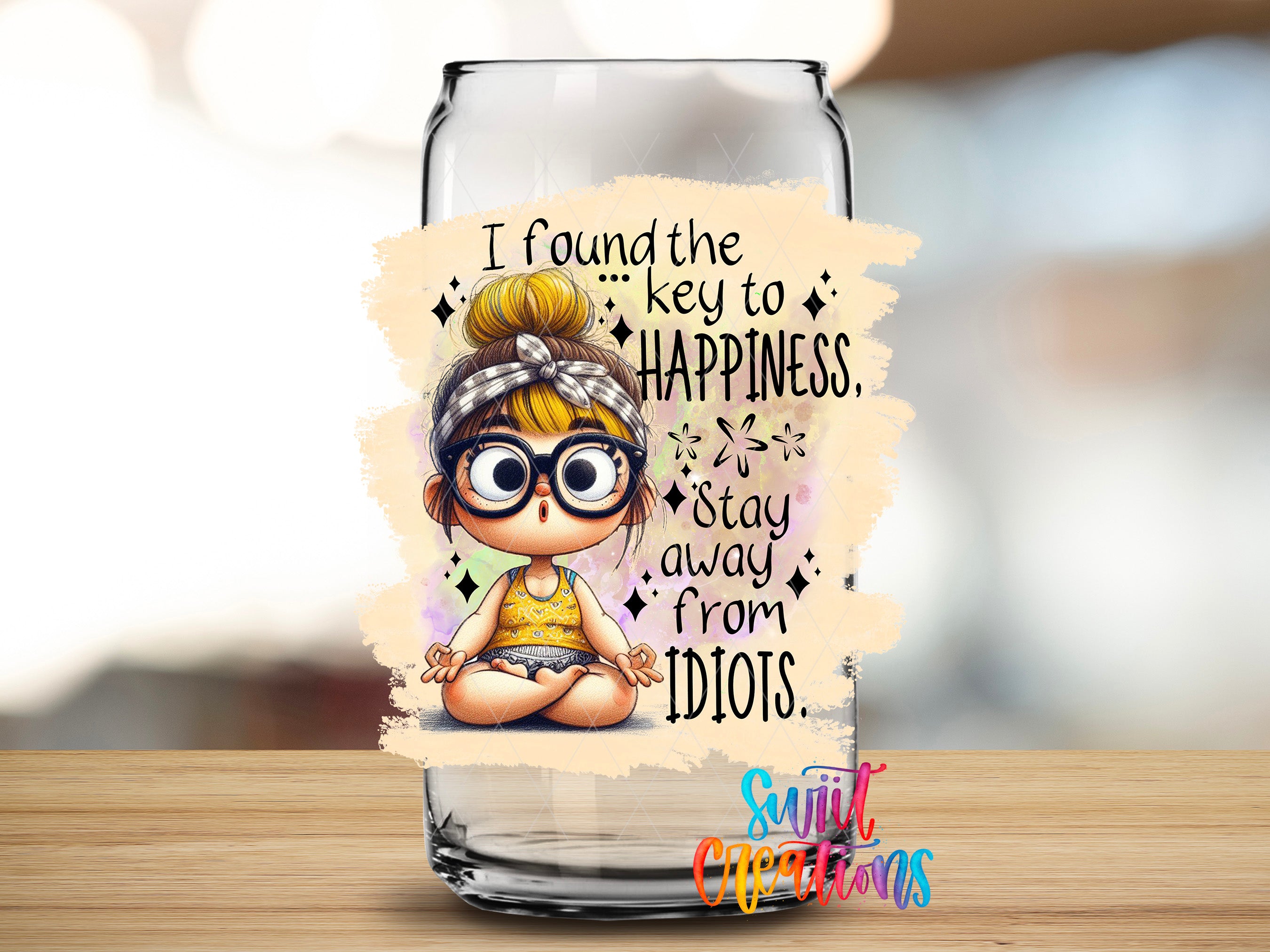 a glass jar with a cartoon illustration of a young girl with glasses and a headband, along with a motivational quote about finding the key to happiness and staying away from Idiots.