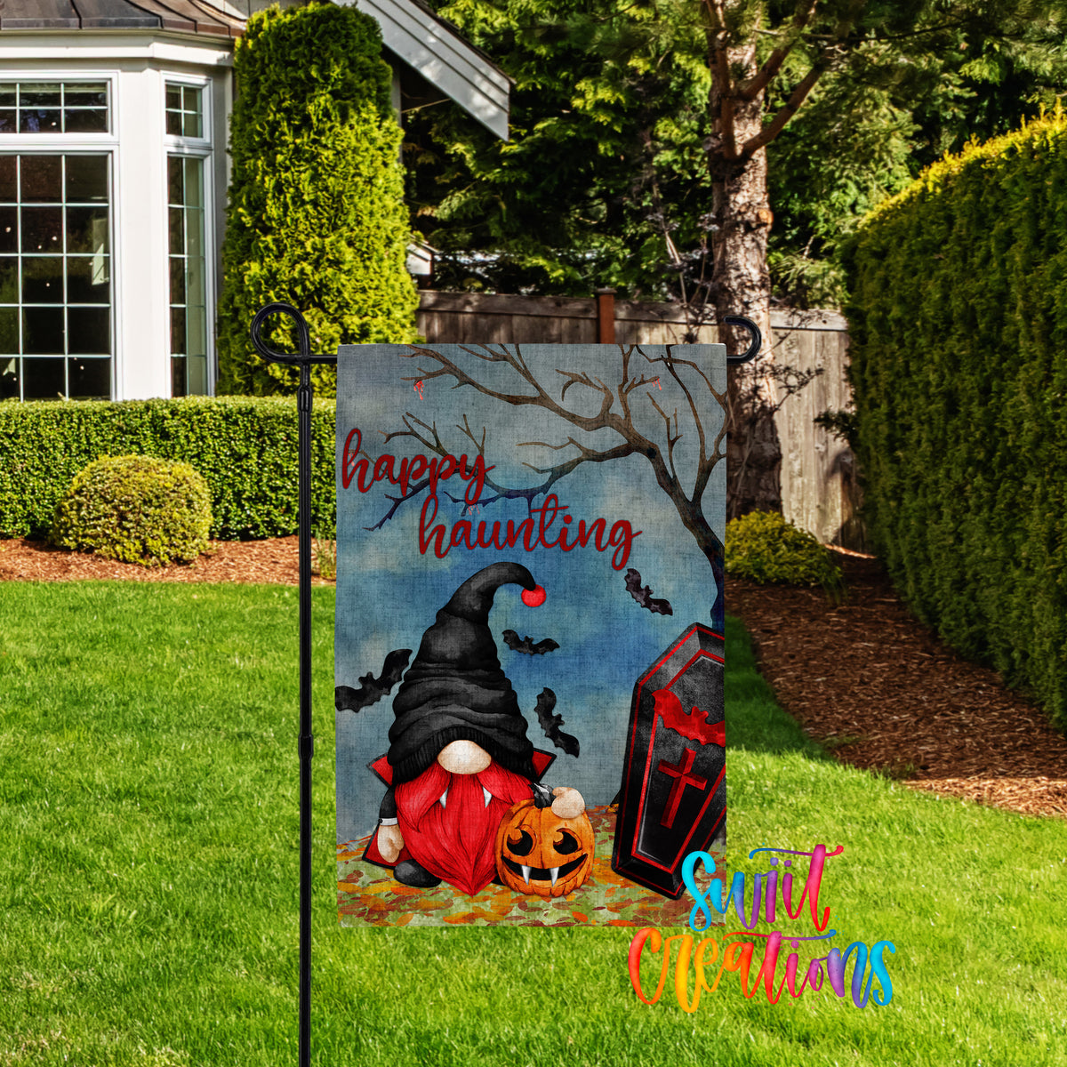 A Halloween-themed garden sign featuring a gnome, a jack-o-lantern, and bats against a spooky background.