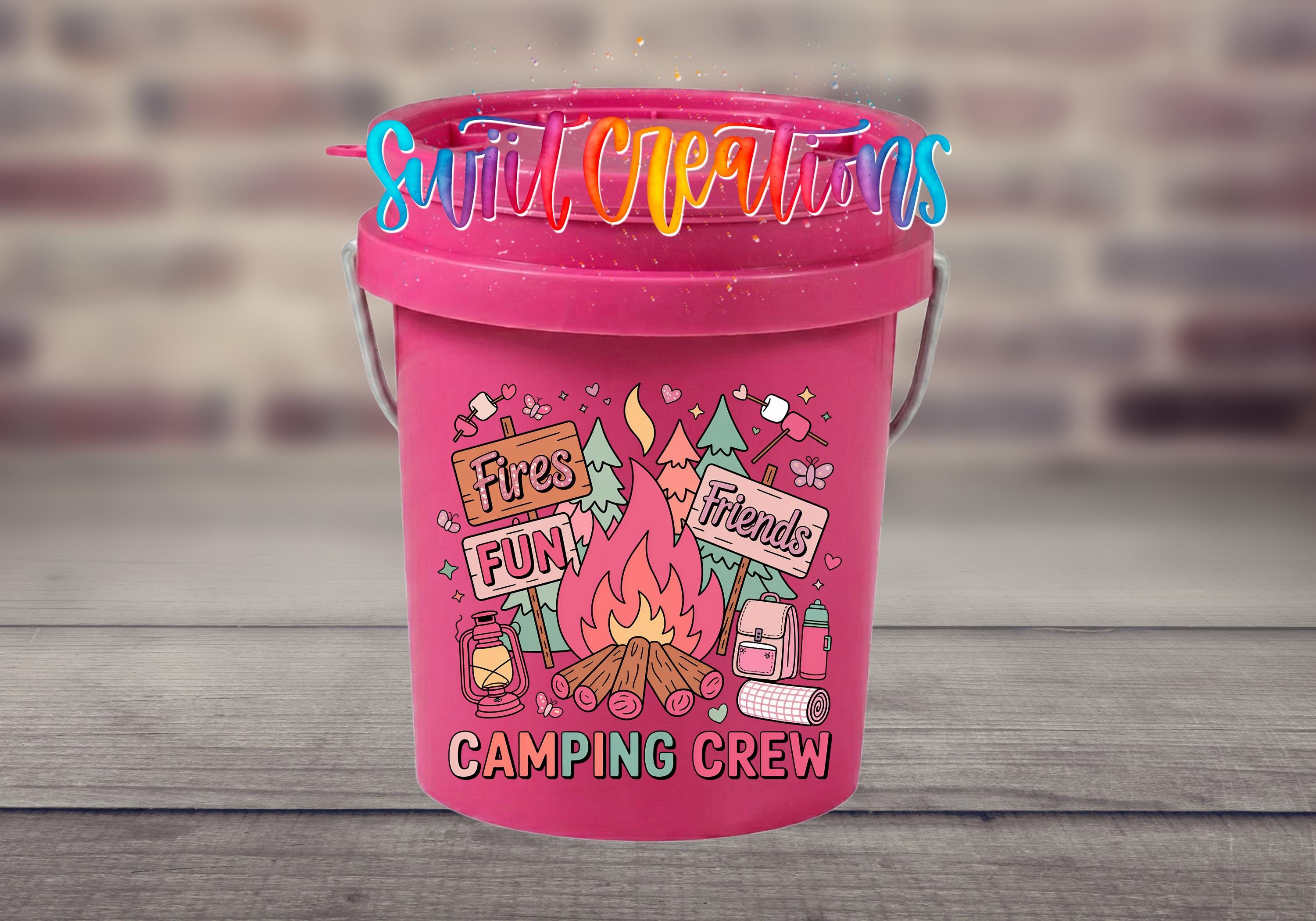 A pink bucket with a vibrant design featuring camping-related elements, such as a campfire, camping gear, and text that says "Fires Fun! Friends Camping Crew".