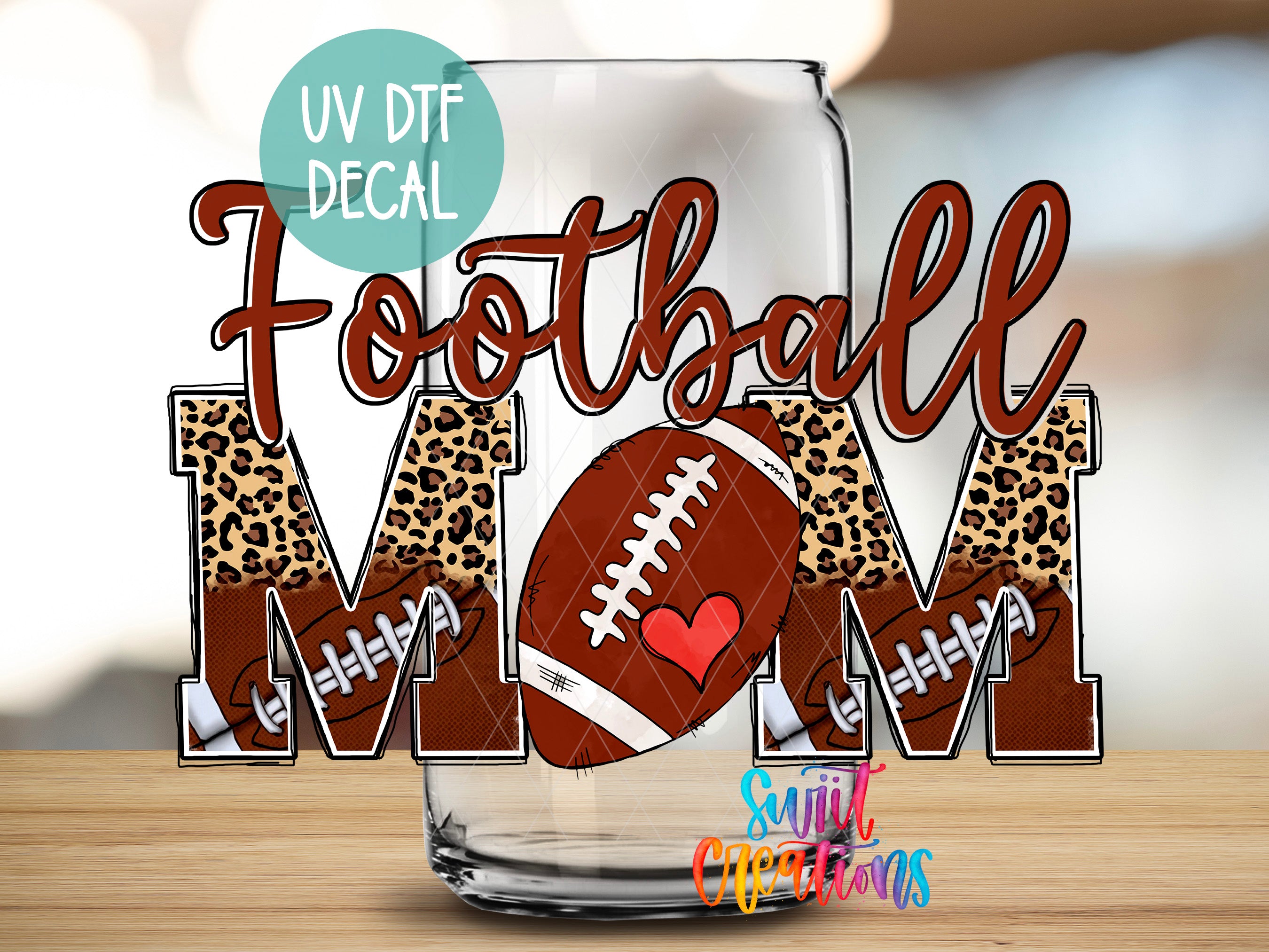 A glass mug with the word "Football Mom" written on it, along with a football graphic and leopard print elements.