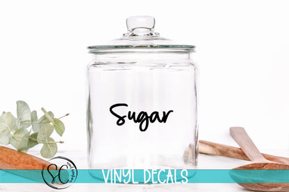 a glass jar with the word sugar written on it