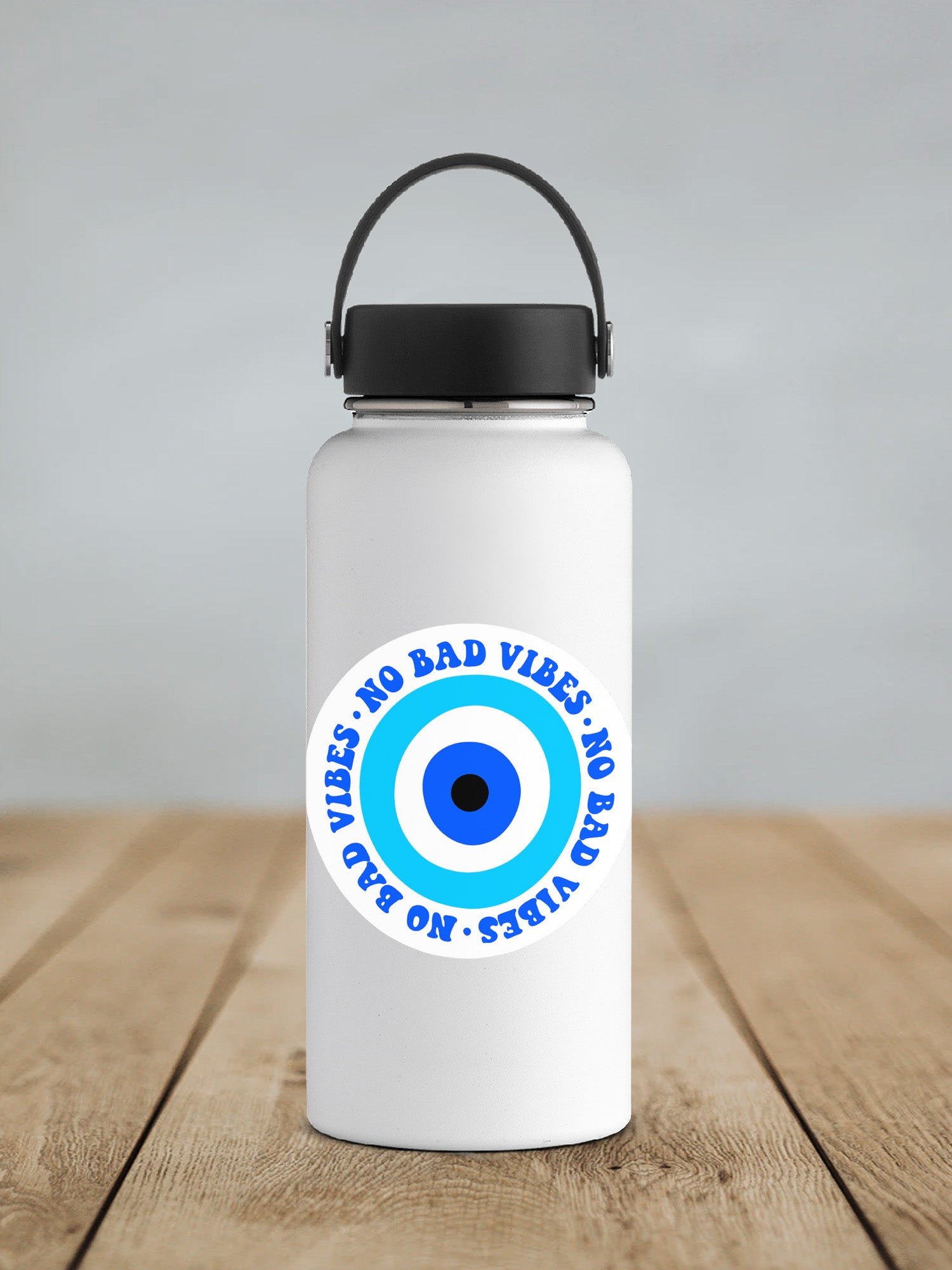 a white water bottle with a blue eye on it