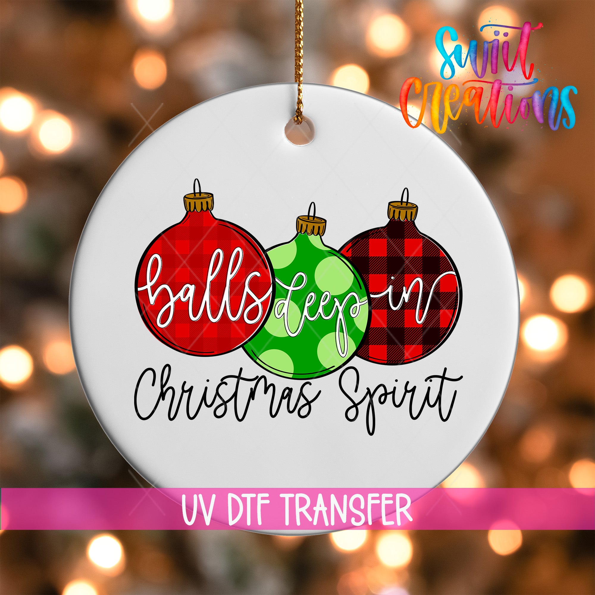 A white ornament with three Christmas ornaments hanging from a string, each with a different color and pattern. The ornament in the center has a green polka dot design, while the other two have red and black plaid patterns. The text "balls deep in Christmas spirit" is written on the ornament, and the image is described as a "UV DFT TRANSFER" and "Sweet Operations".