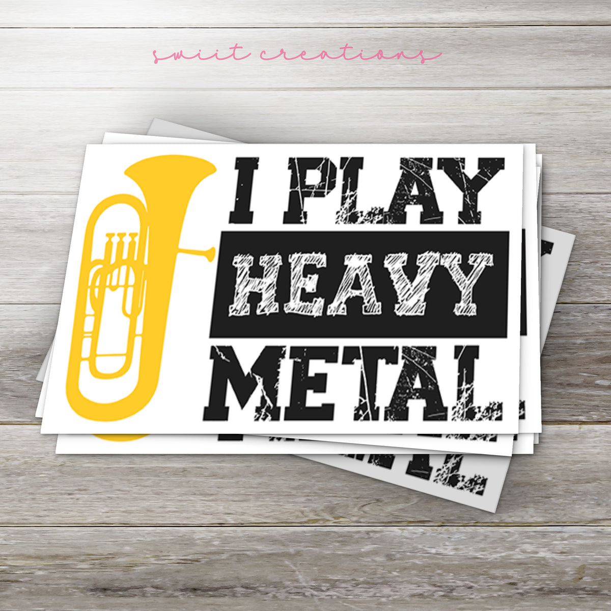 i play heavy metal stickers on a wooden surface