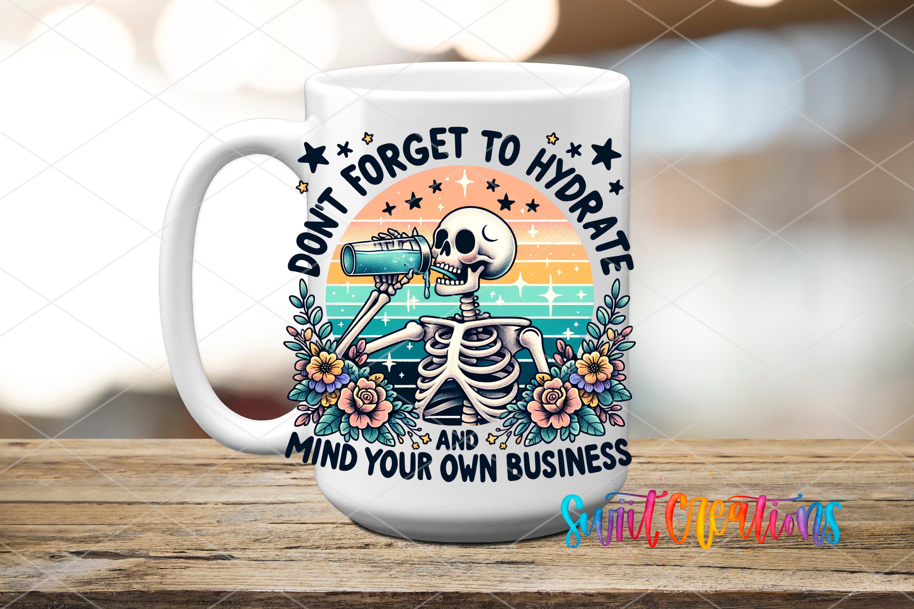 A white ceramic mug with a colorful design featuring a skeleton drinking from a cup, surrounded by flowers and stars. The text on the mug reads "Don't forget to hydrate and mind your own business".