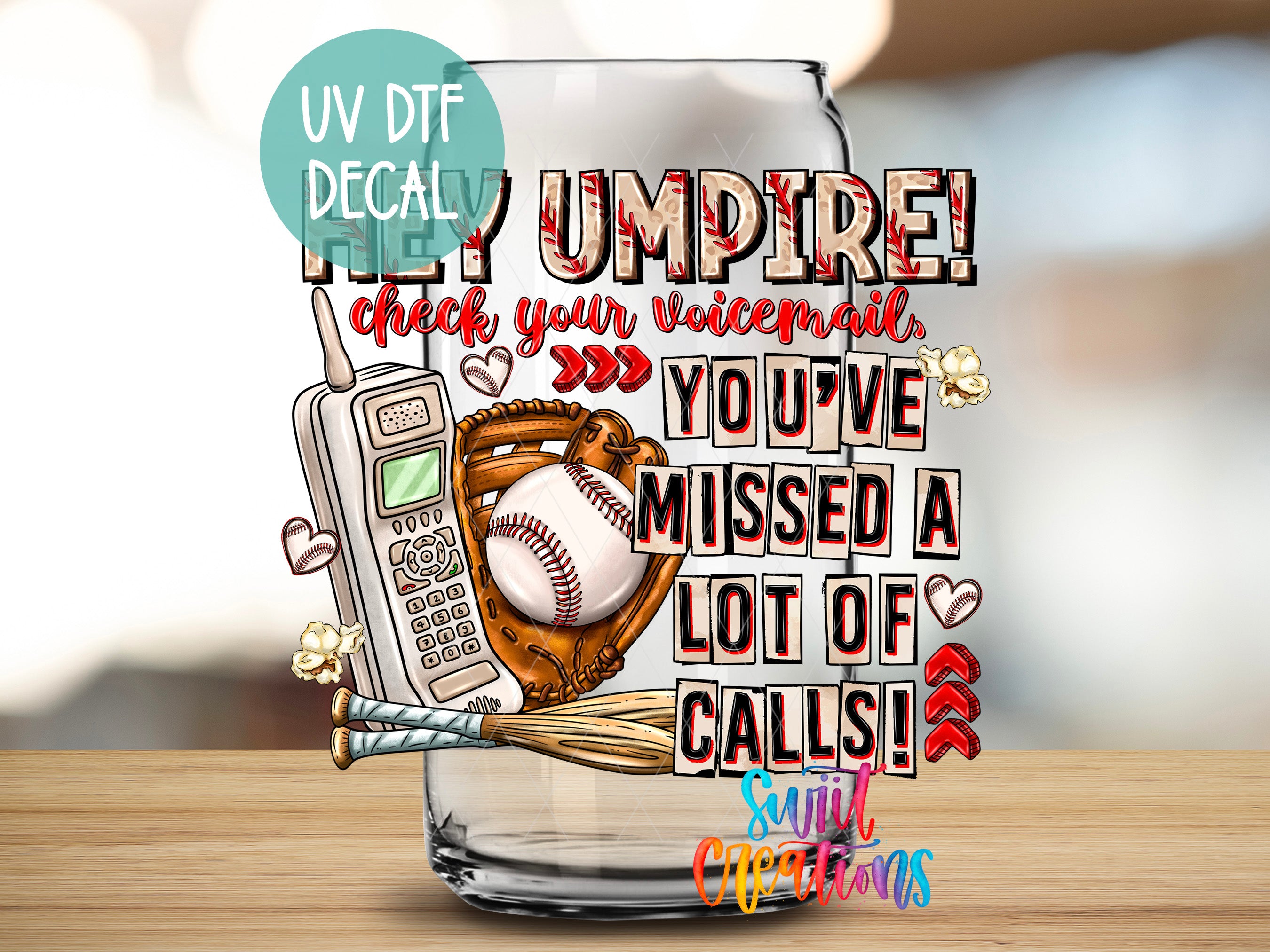 a glass jar with a baseball motif, along with various objects such as a baseball glove, a phone, and a baseball. The text on the jar reads "UV DFT DECAL" and "HEY UMPIRE! check your voicemail, YOU'VE MESSED A LOT OF CALLS!"
