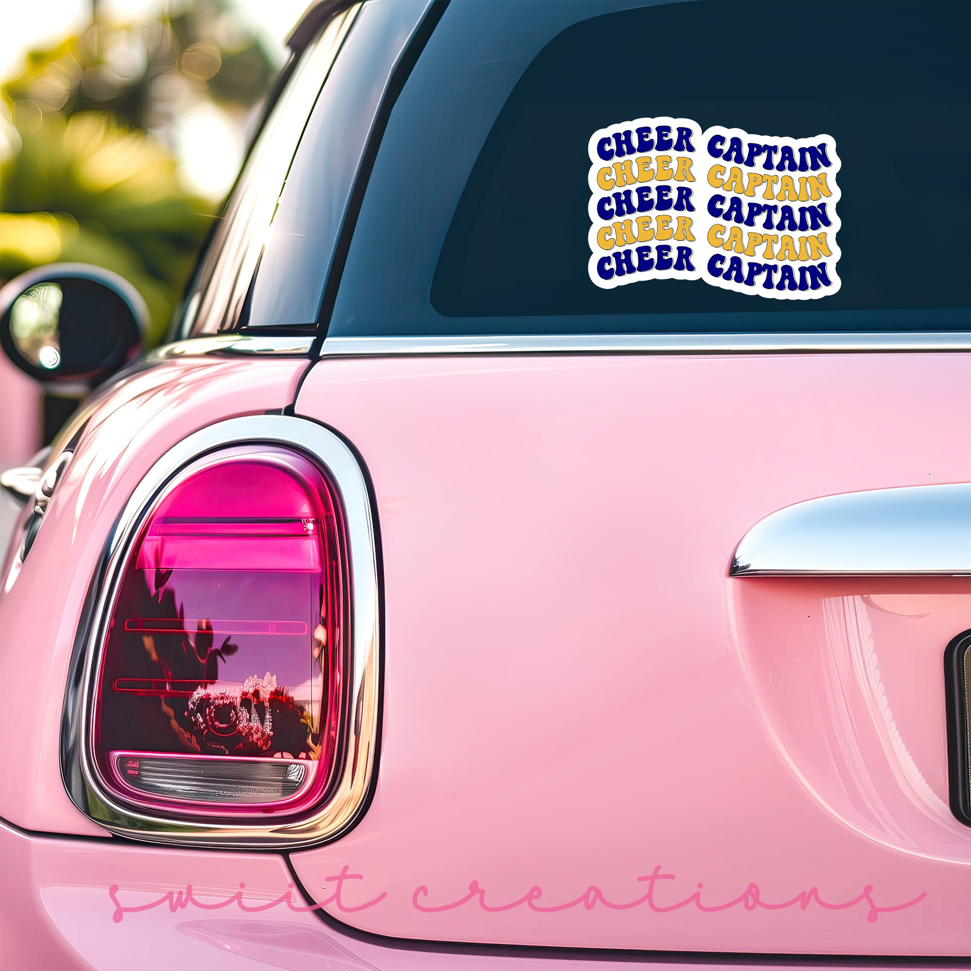 a close up of a pink car with a sticker on it