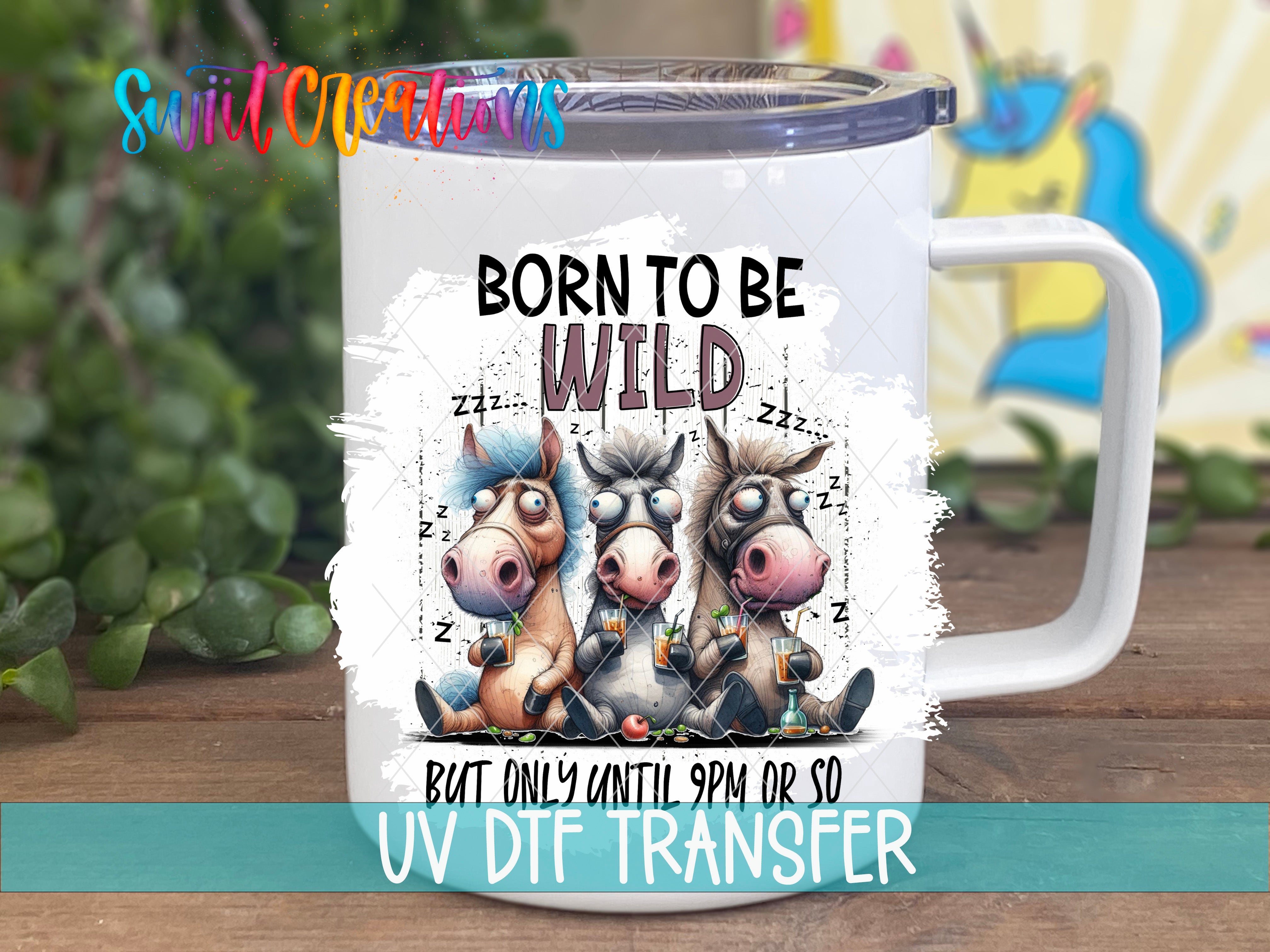 A white mug with a printed design featuring three cartoon horses and the text "Born to be wild" along with the phrase "But only until 9pm or so".