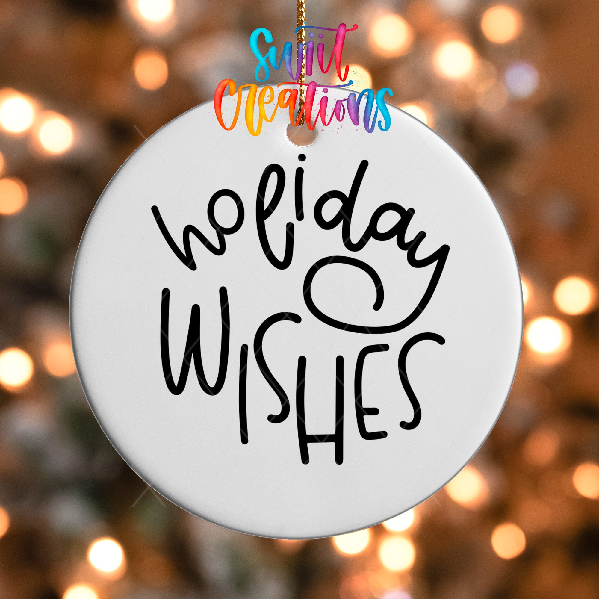 A white ornament with the text "Holiday Wishes" written on it, hanging against a background of colorful lights.